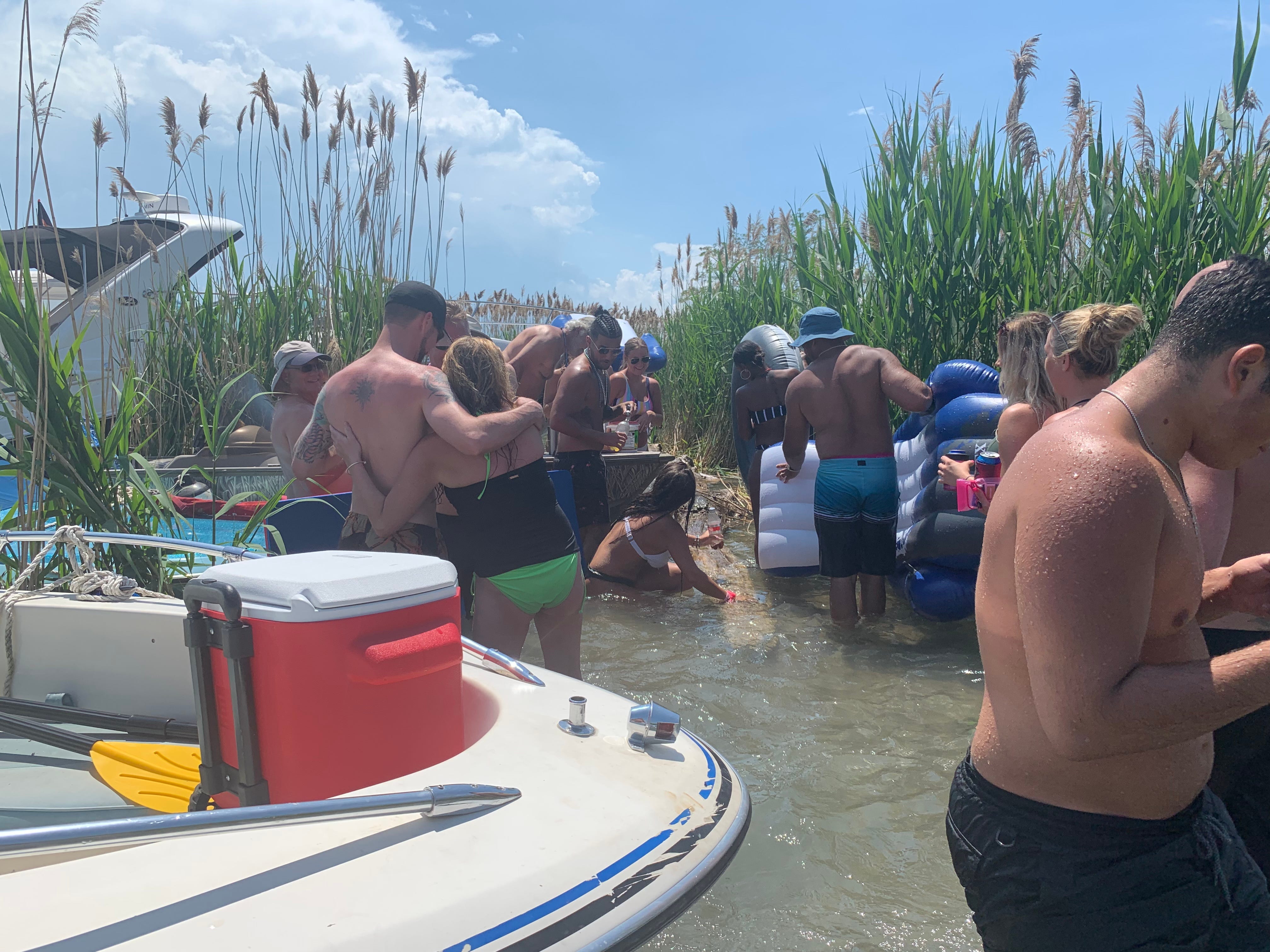 Jobbie Nooner revelers congragate in the shallow water on what was a beach area in previous years...  eliminated this year by high lake water levels on Lake St. Clair at Gull Island.