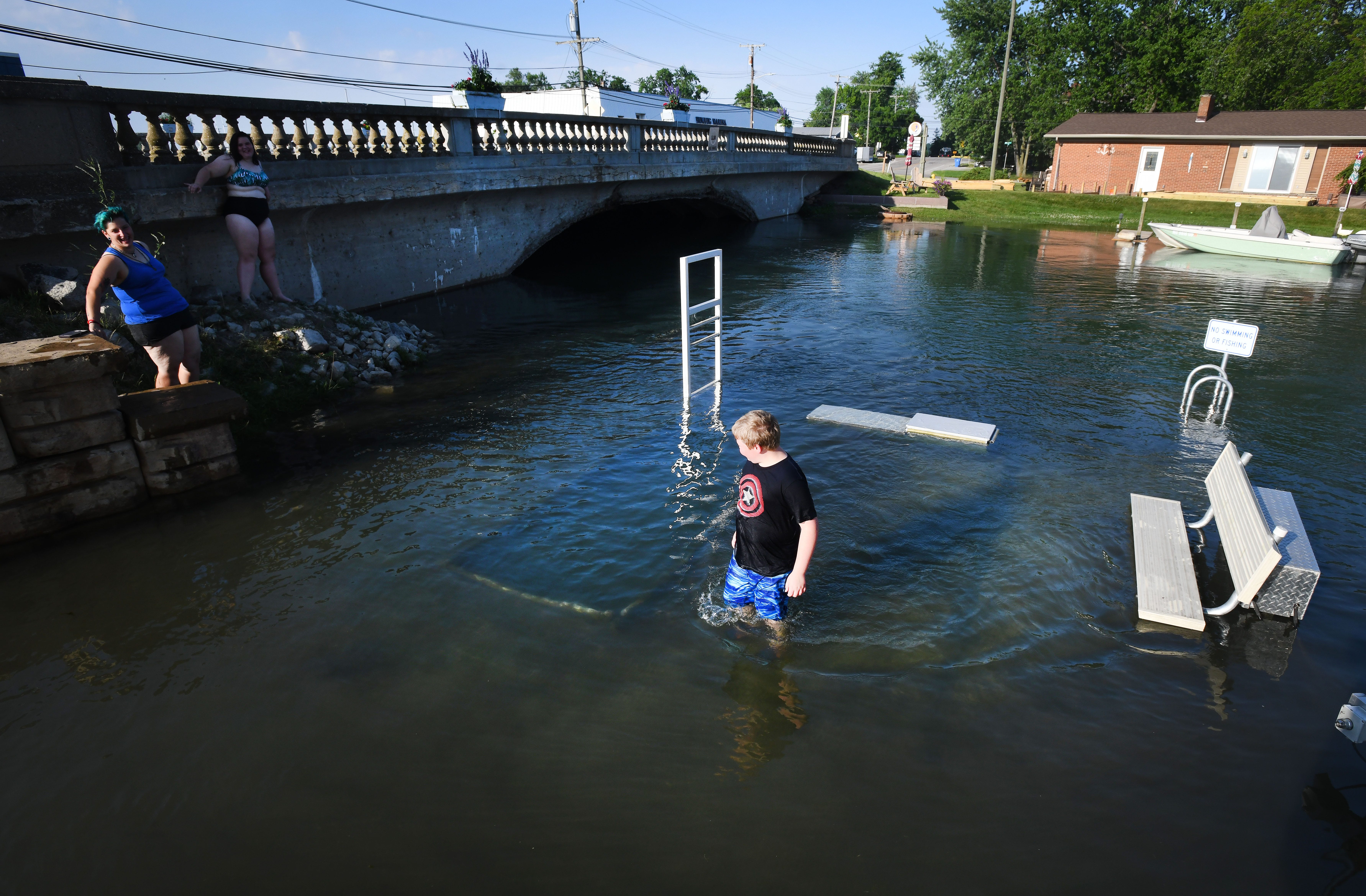 Jack Fitzgerald, 10, walks on a dock that is usually a kayak launch when not under water in downtown Gibraltar.