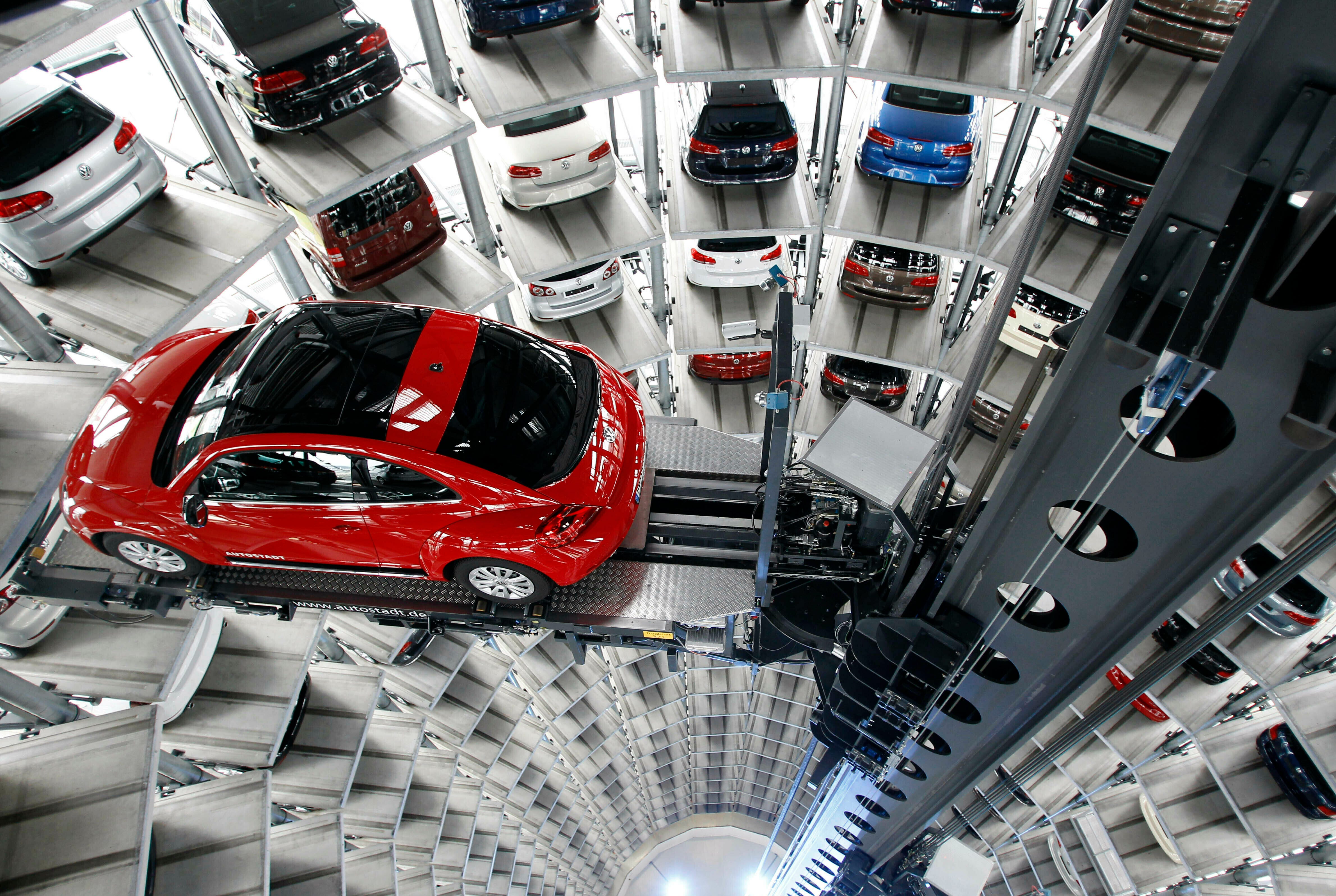 In this March 12, 2012, file photo a Volkswagen New Beetle car is lifted inside a delivery tower after the company's annual press conference in Wolfsburg, Germany.