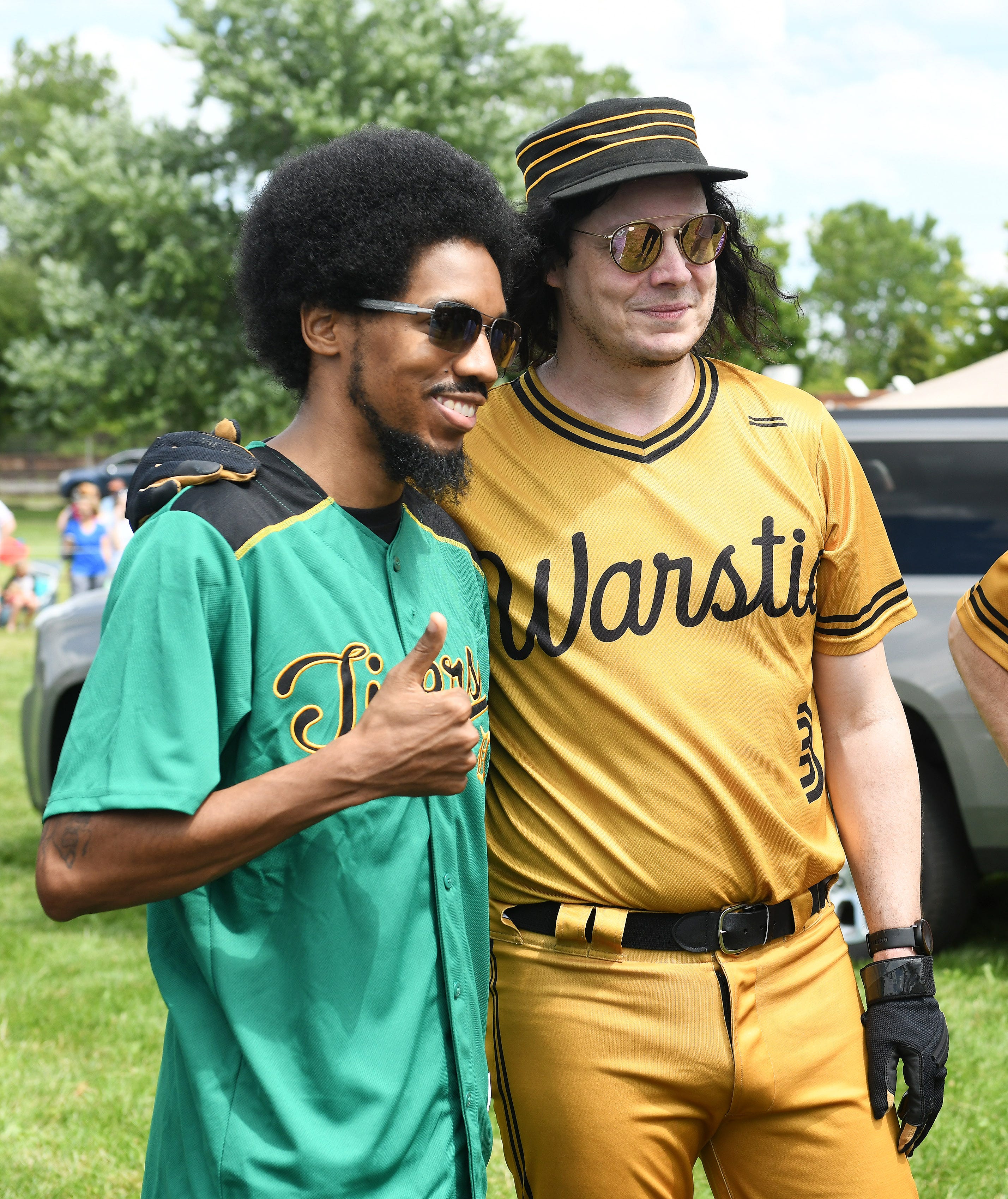 Adonis Ventura gives a thumbs up getting a photo taken with Jack White, right, after the game.