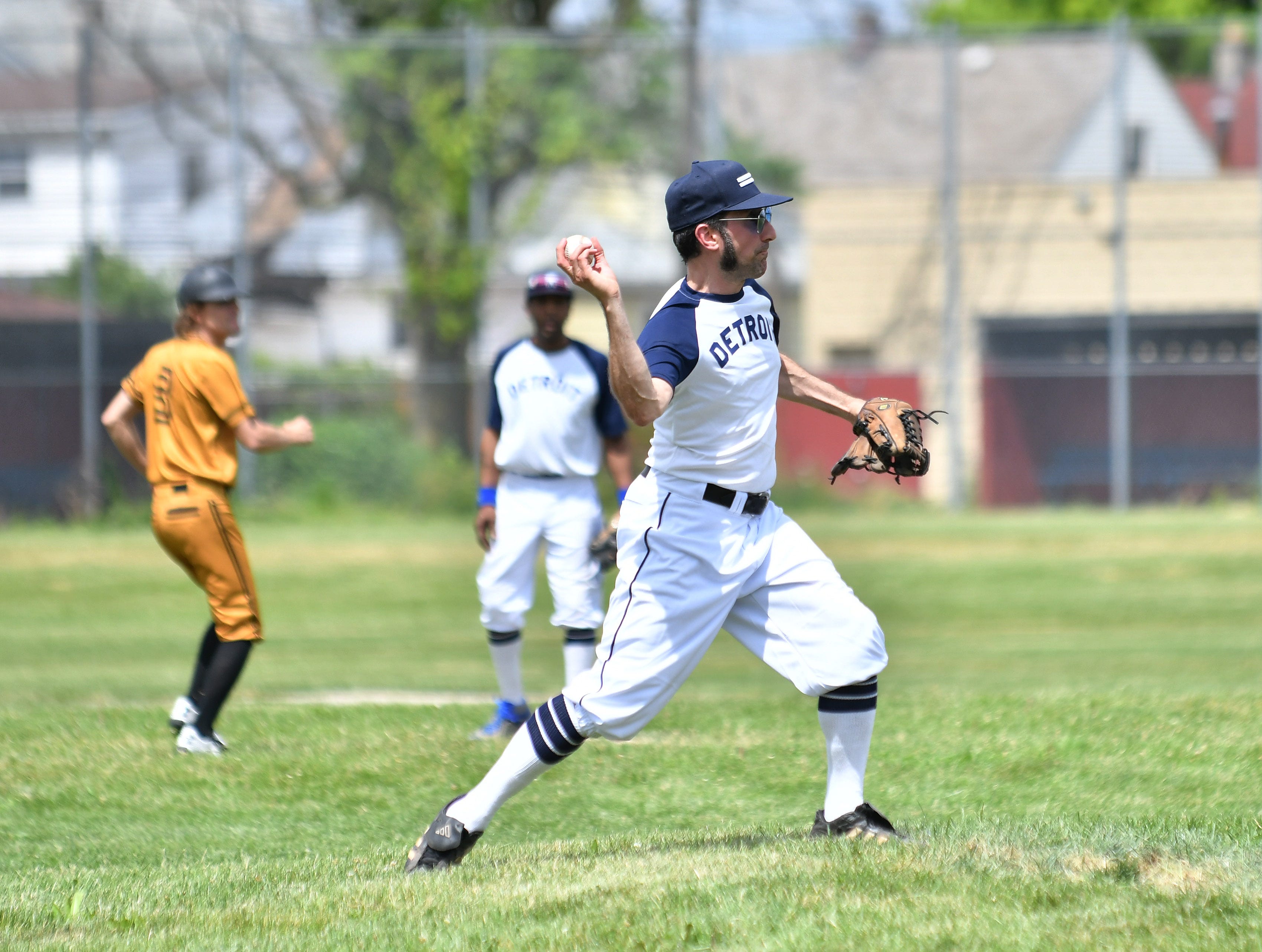 Event organizer Dave Mesrey with the Friends of Historic Hamtramck Stadium makes a throw to first base.