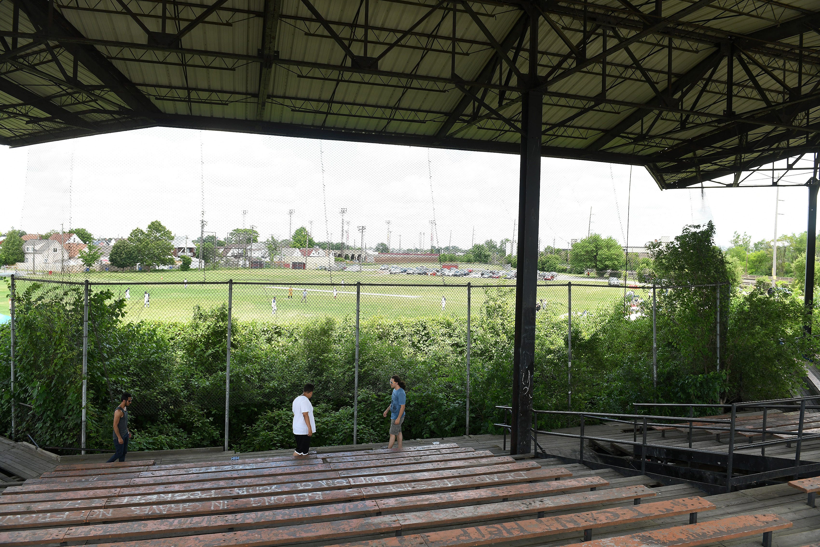 People check out the stands of Historic Hamtramck Stadium during a sandlot style baseball game.