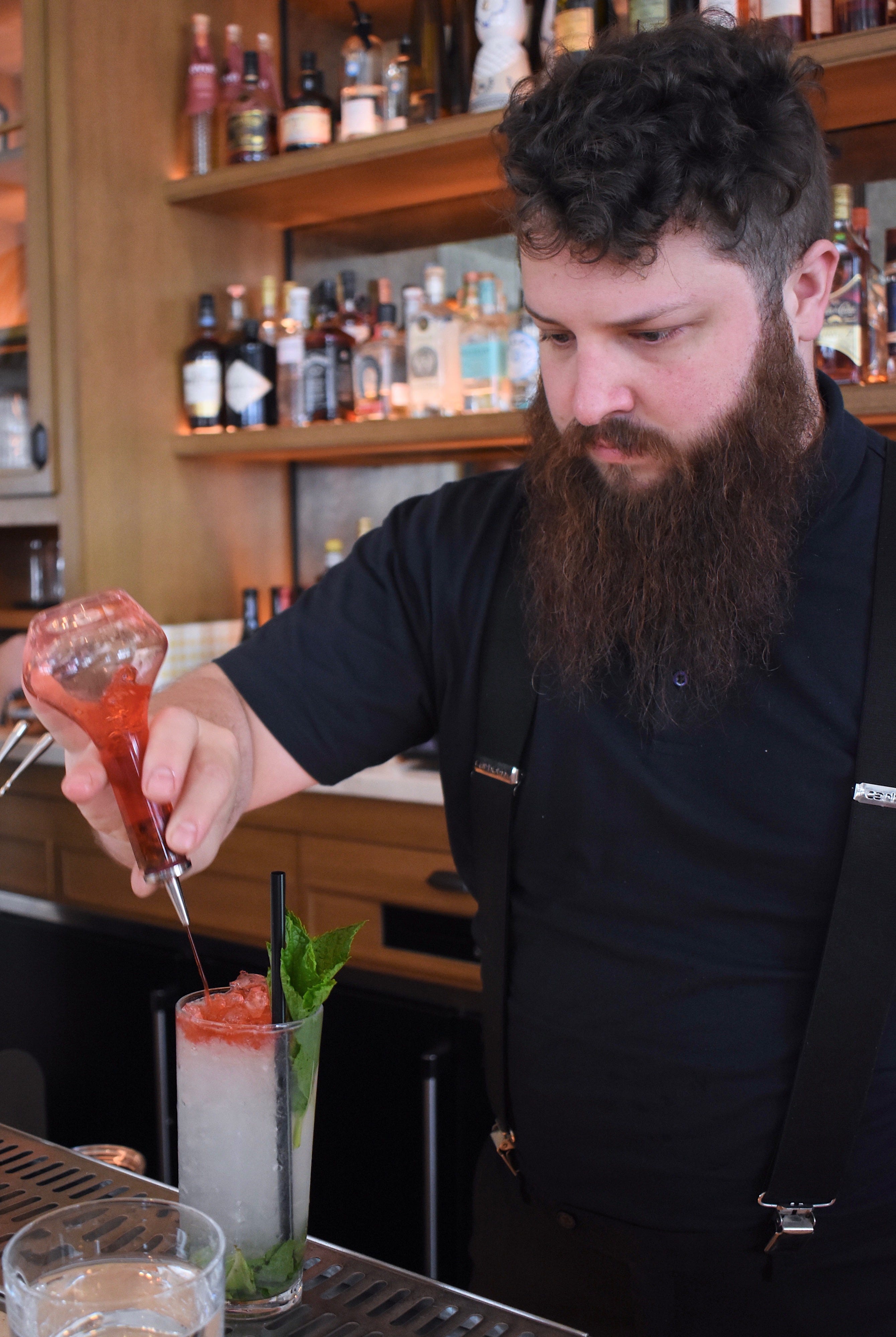 Lead bartender Chas Williams tops a house cocktail called the " Tricolore Spritz " with Peychaud ’ s bitters. The drink is a mixture of lime, cucumber syrup, gin, and Prosecco that bears the same colors as the Italian flag.