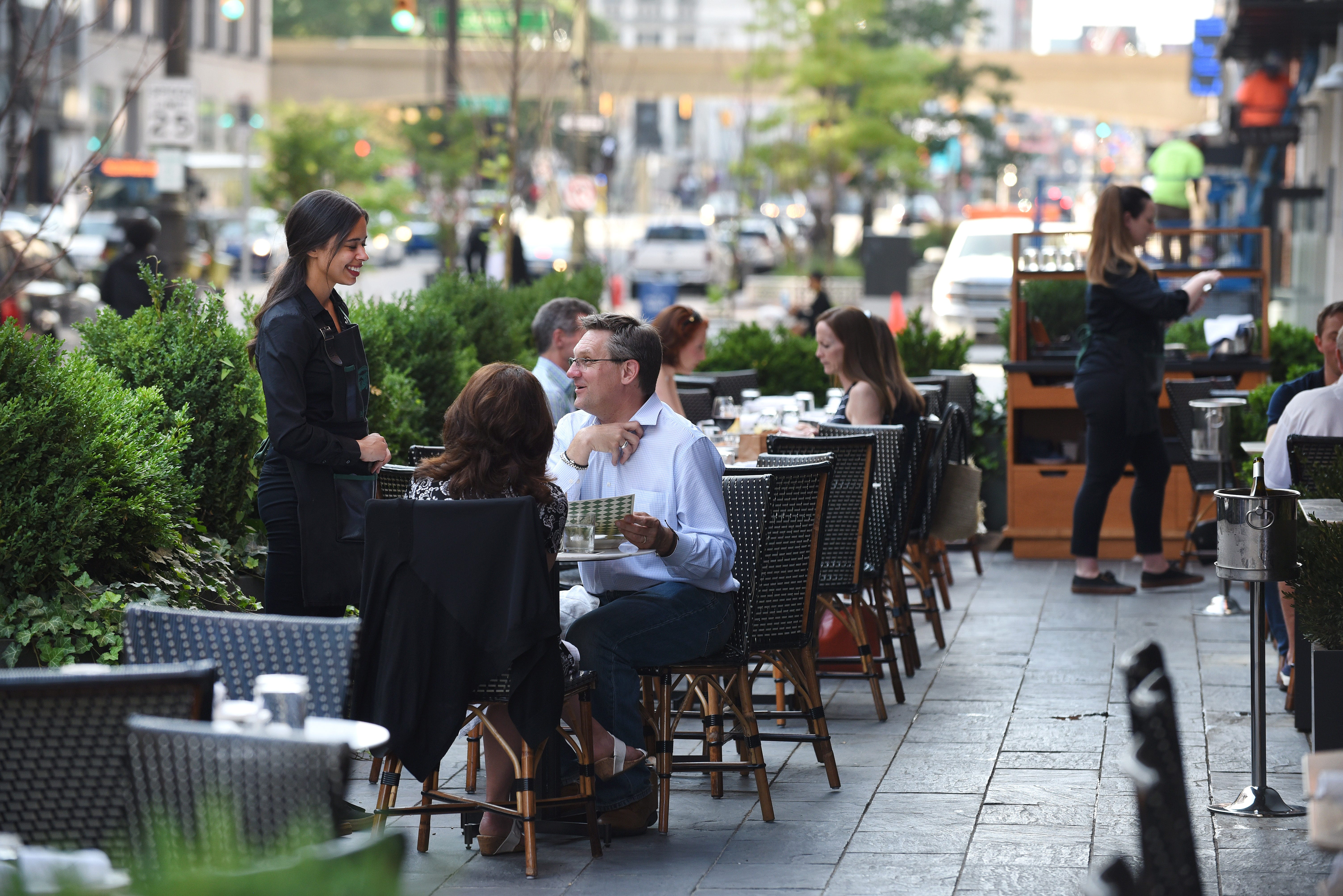 People enjoy the patio area at the San Morello restaurant along Woodward Avenue in Detroit.