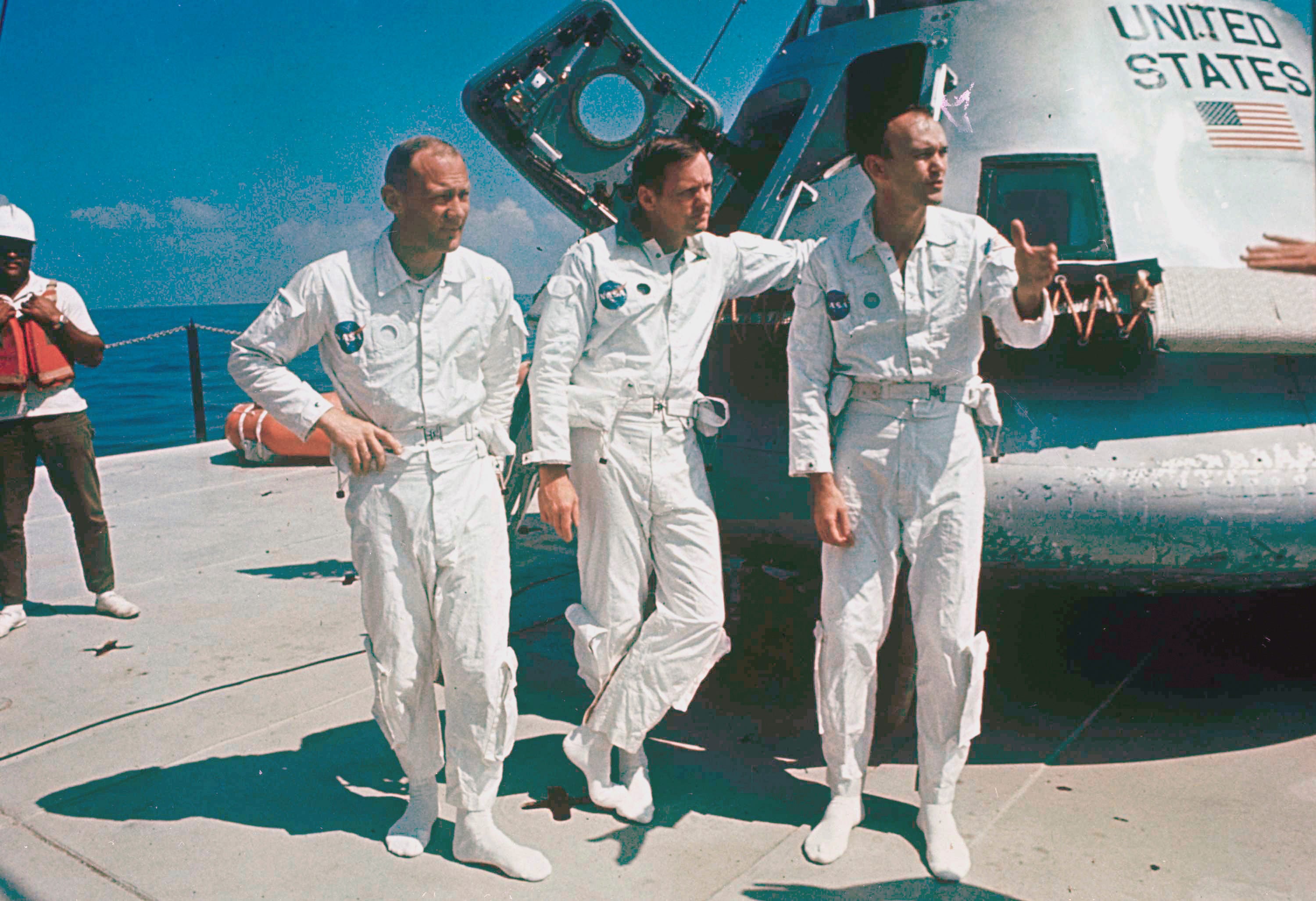 Apollo 11 astronauts stand next to their spacecraft in 1969, from left:  Col. Edwin E. Aldrin, lunar module pilot; Neil Armstrong, flight commander; and Lt. Michael Collins, command module pilot.