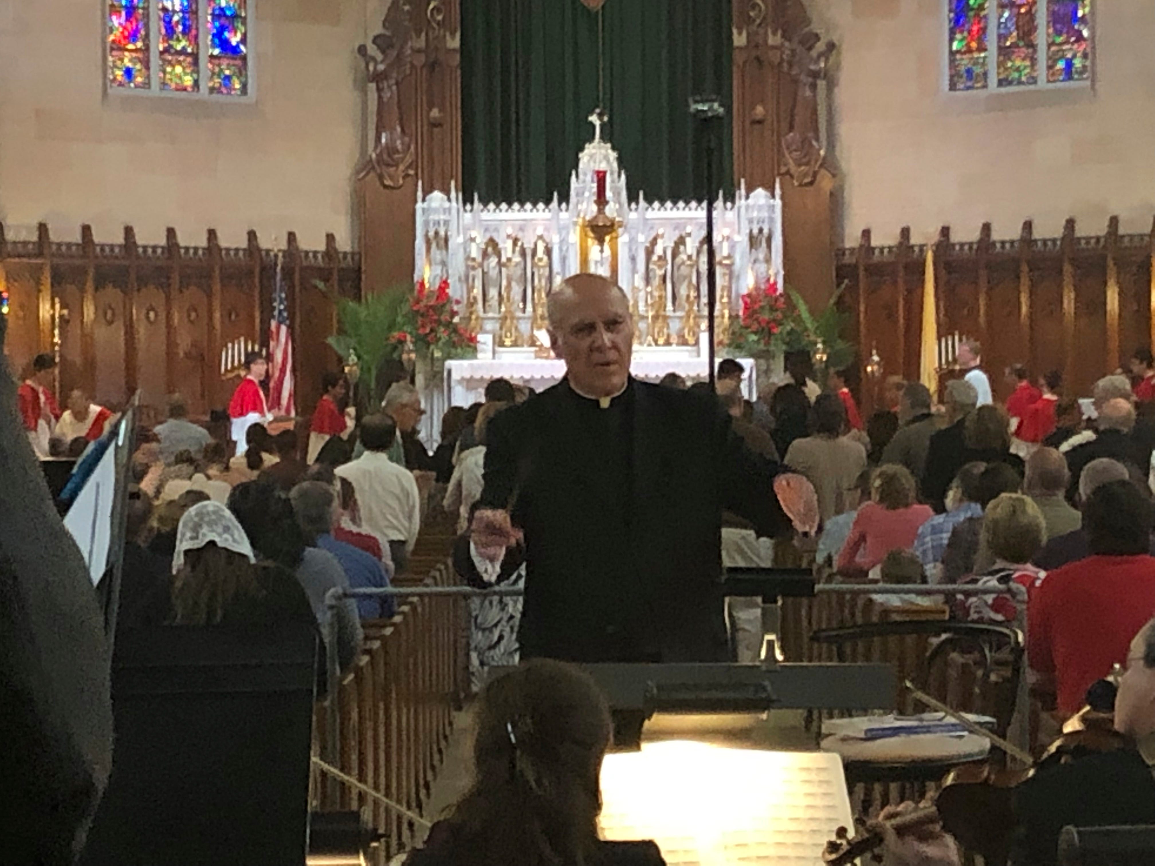 The Rev. Eduard Perrone conducts a choir during a Mass at The Assumption of the Blessed Virgin Mary Church in Detroit on June 9. Perrone was a co-founder of a small nonprofit organization called Opus Bono Sacerdotii which has provided money, shelter, transport, legal help and other support to priests accused of sexual abuse.