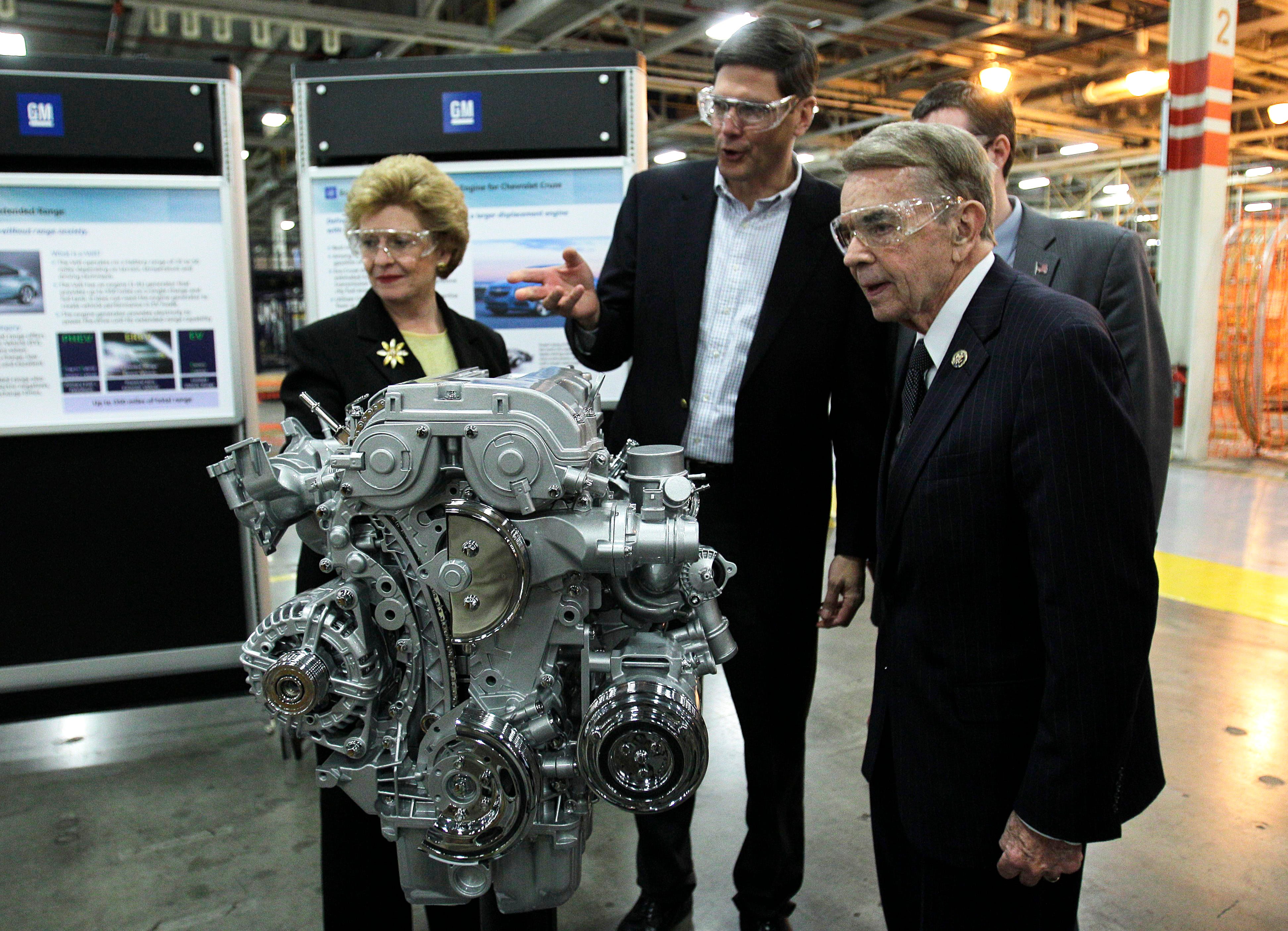 General Motors Assistant Chief Engineer Mike Katerberg, center, shows a model of a new engine to Sen. Debbie Stabenow, D-Lansing, and Rep. Dale Kildee at the Flint Engine plant on Nov. 24, 2010.