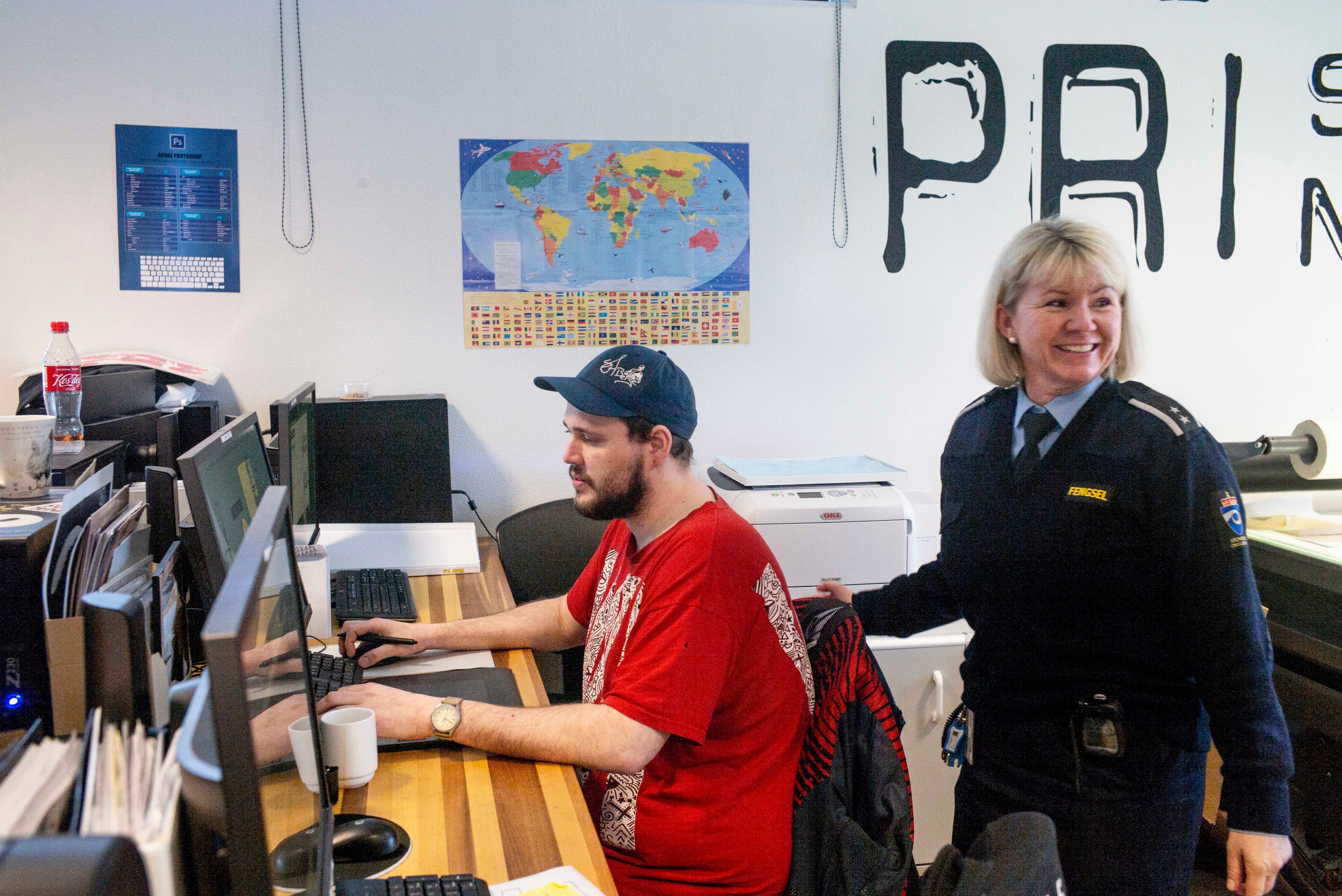 Inmate Fredrik Soerfjordmo designs artwork on a computer, watched by works manager Janne Hasle, in the digital print shop at Halden Prison in Norway. Staff at Halden are not armed. Instead, they practice " dynamic security, " a disciplinary system based on relationship-building, communication and mutual trust.