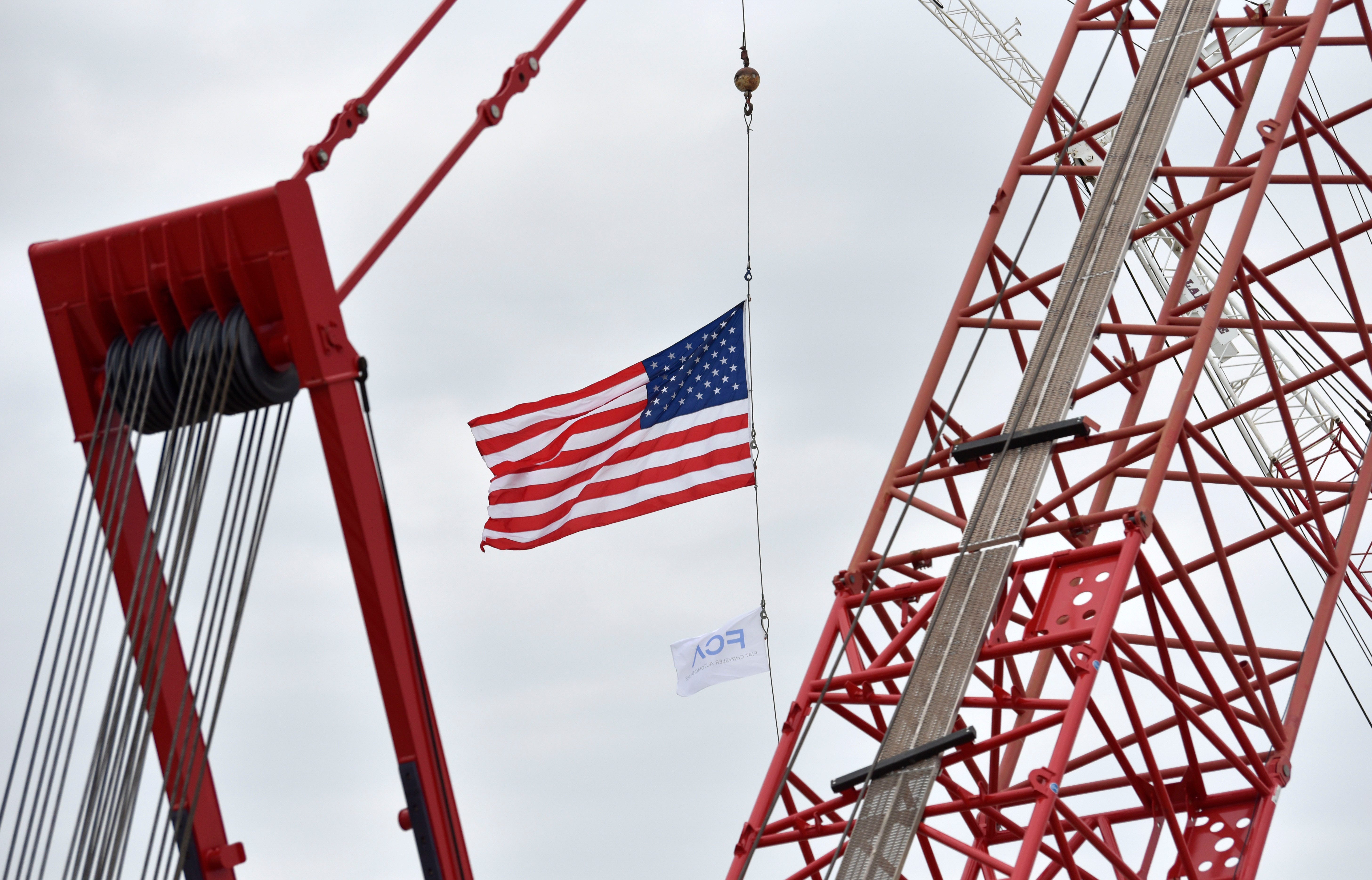 The U.S. flag and FCA flag blow in the breeze in the under-construction paint shop area.