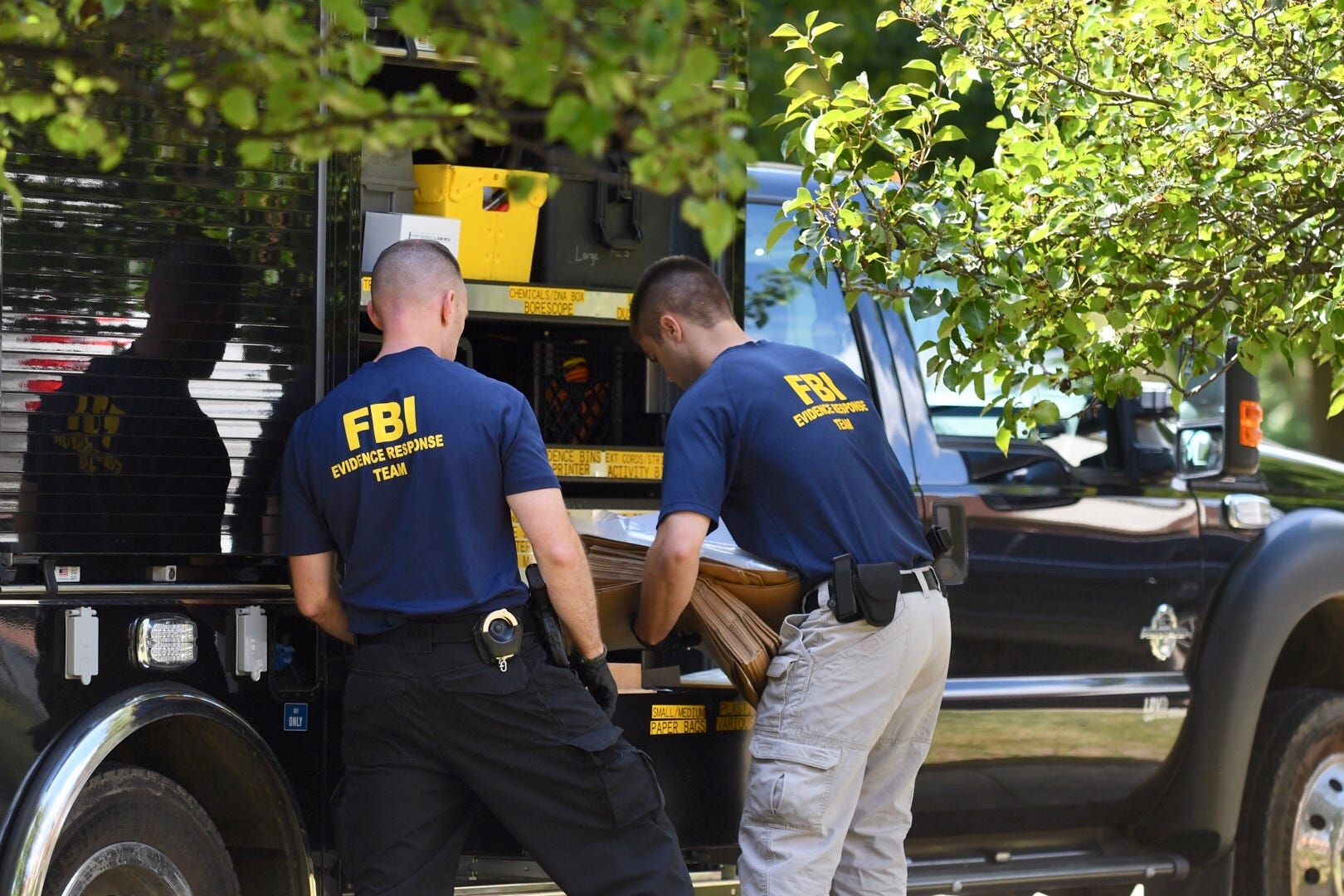 FBI agents load material collected from the home of UAW President Gary Jones during a search of his Canton Township home.