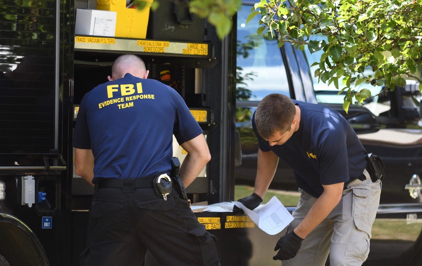 FBI agents load items collected from the home of UAW President Gary Jones during a search of his Canton Township home.