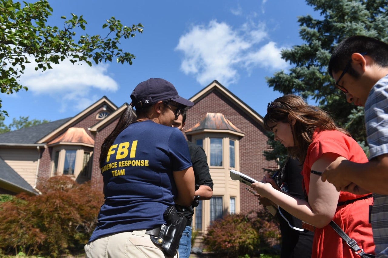 FBI special Agent Mara Schneider speaks to the news media outside the home of UAW President Gary Jones after the agency searched the residence.