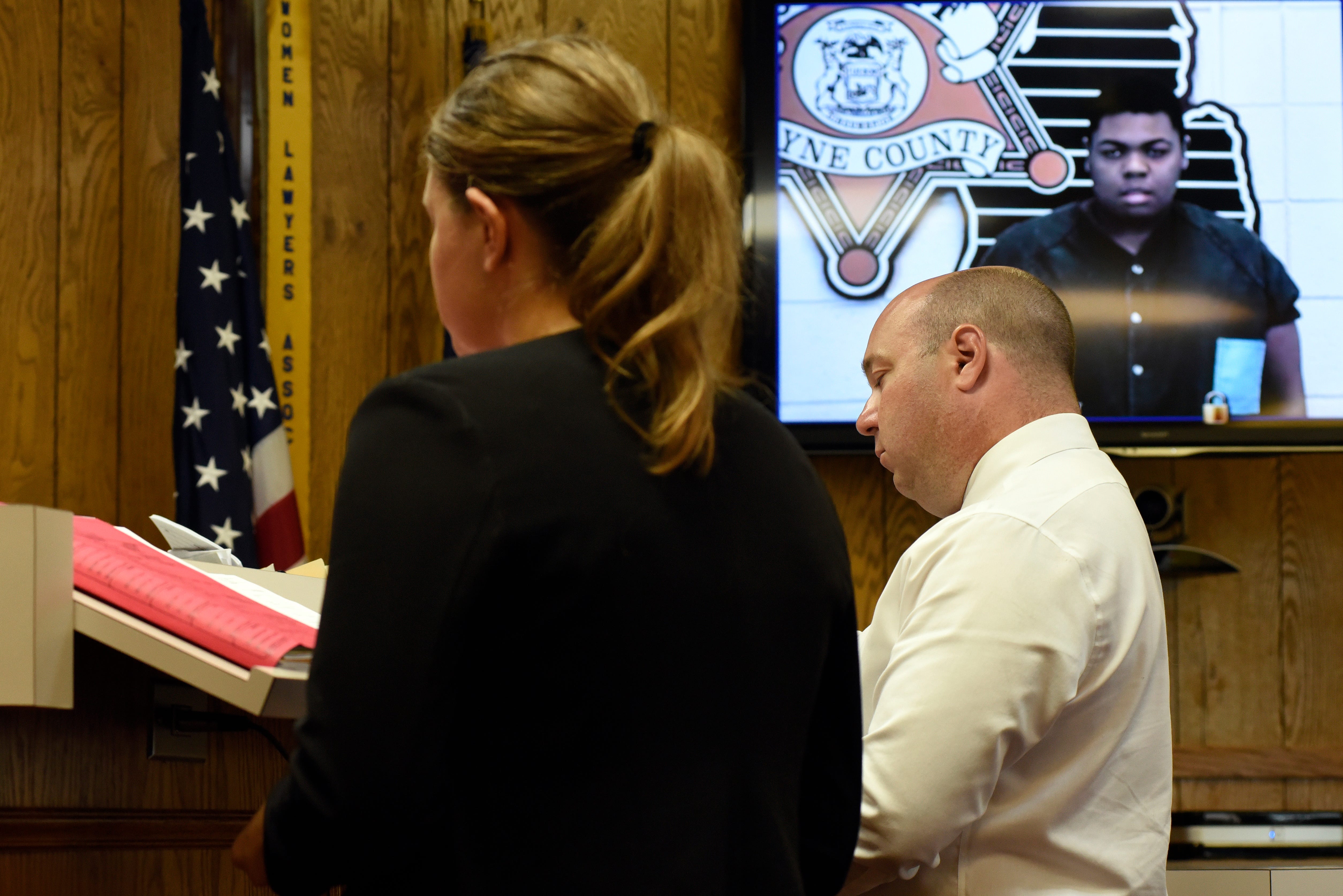Wayne County Assistant Prosecutor Elizabeth Dornik, left, and defense attorney William Amadeo address Judge Laura Mack during a hearing for Darian Michael Smith-Blackmon, pictured on video screen,  Aug. 27, 2019, at 29th District Court in Wayne, Mich. Blackmon was found incompetent to stand trial in a man's death but prosecutors could still charge him if he becomes competent.