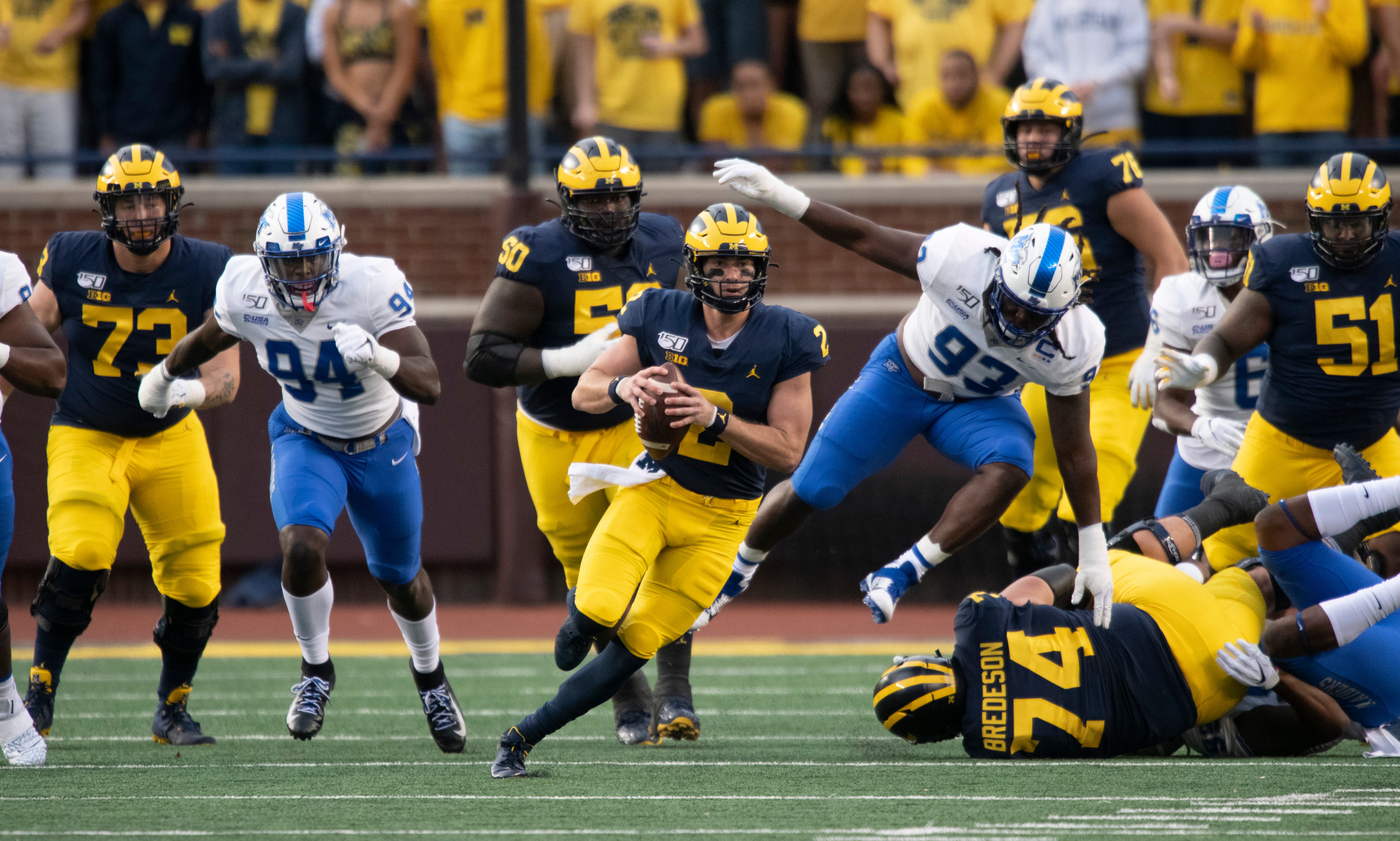 Michigan quarterback Shea Patterson runs the ball up the middle on the first play from scrimmage, but fumbles the ball away on the play in the first quarter.