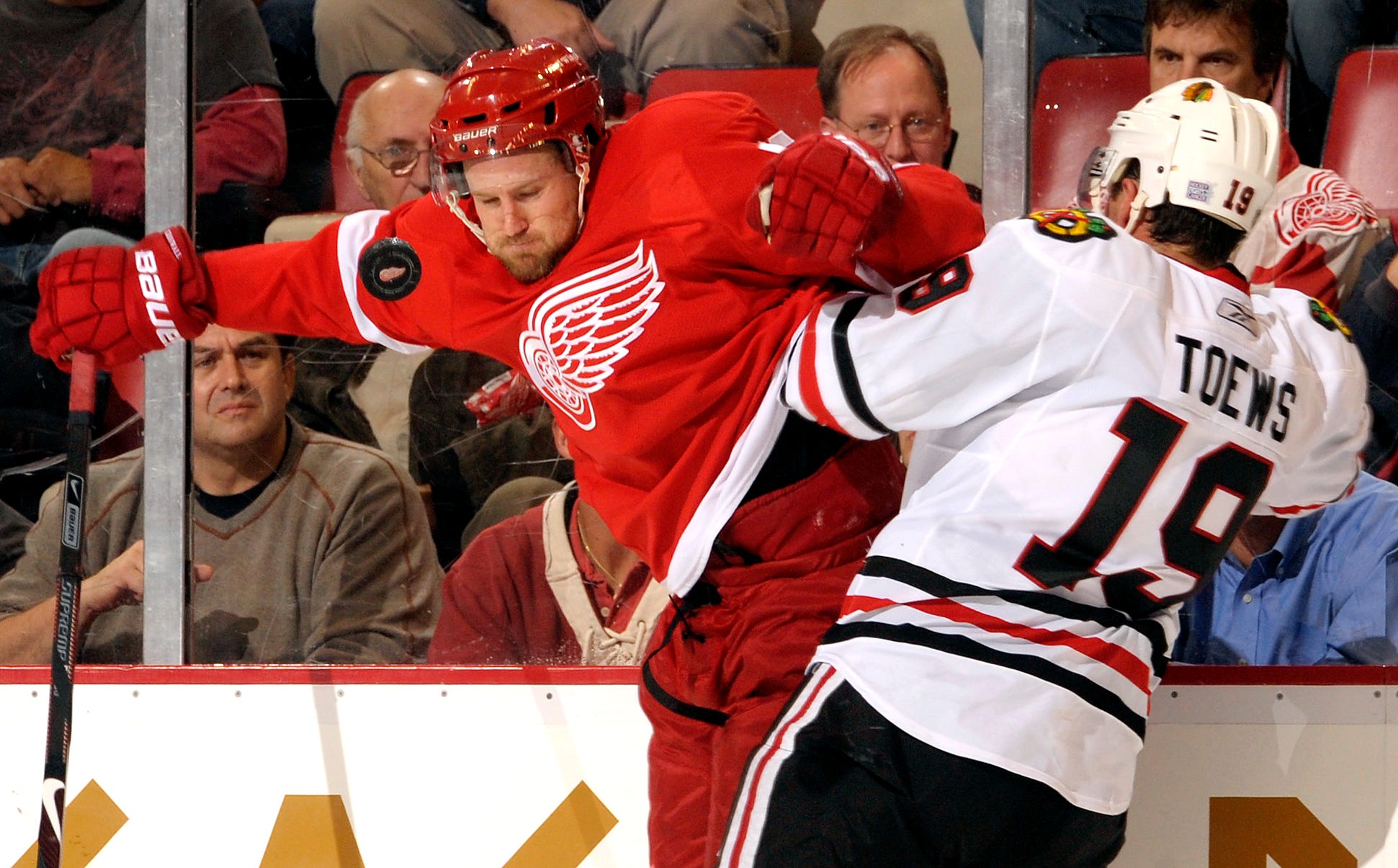 Detroit ' s Niklas Kronwall and Chicago ' s Jonathan Toews fight for the puck during the home opener at Joe Louis Arena on Oct. 8, 2009.