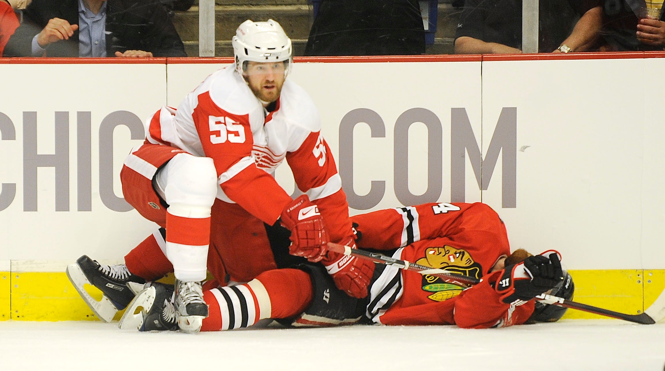 Detroit Red Wings defenseman Niklas Kronwall (55) kneels over Chicago Blackhawks right wing Martin Havlat (24) after knocking him flat with a check in the first period of a playoff game at the United Center in Chicago on May 22,  2009.