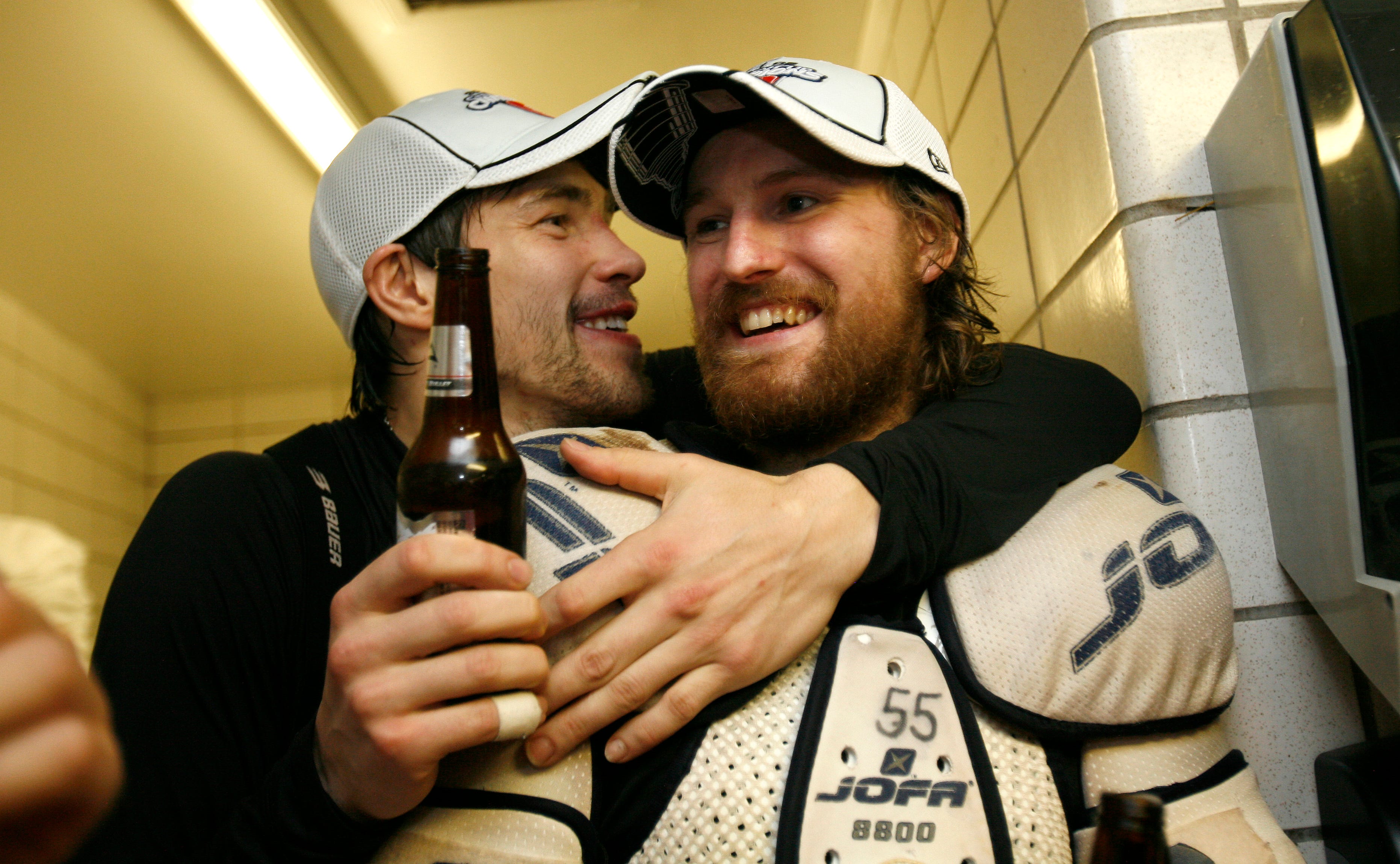 Pavel Datsyuk, left, and Niklas Kronwall celebrate their Stanley Cup victory over the Pittsburgh Penguins in the jubilant visitors dressing room at Mellon Arena in Pittsburgh on June 4, 2008.