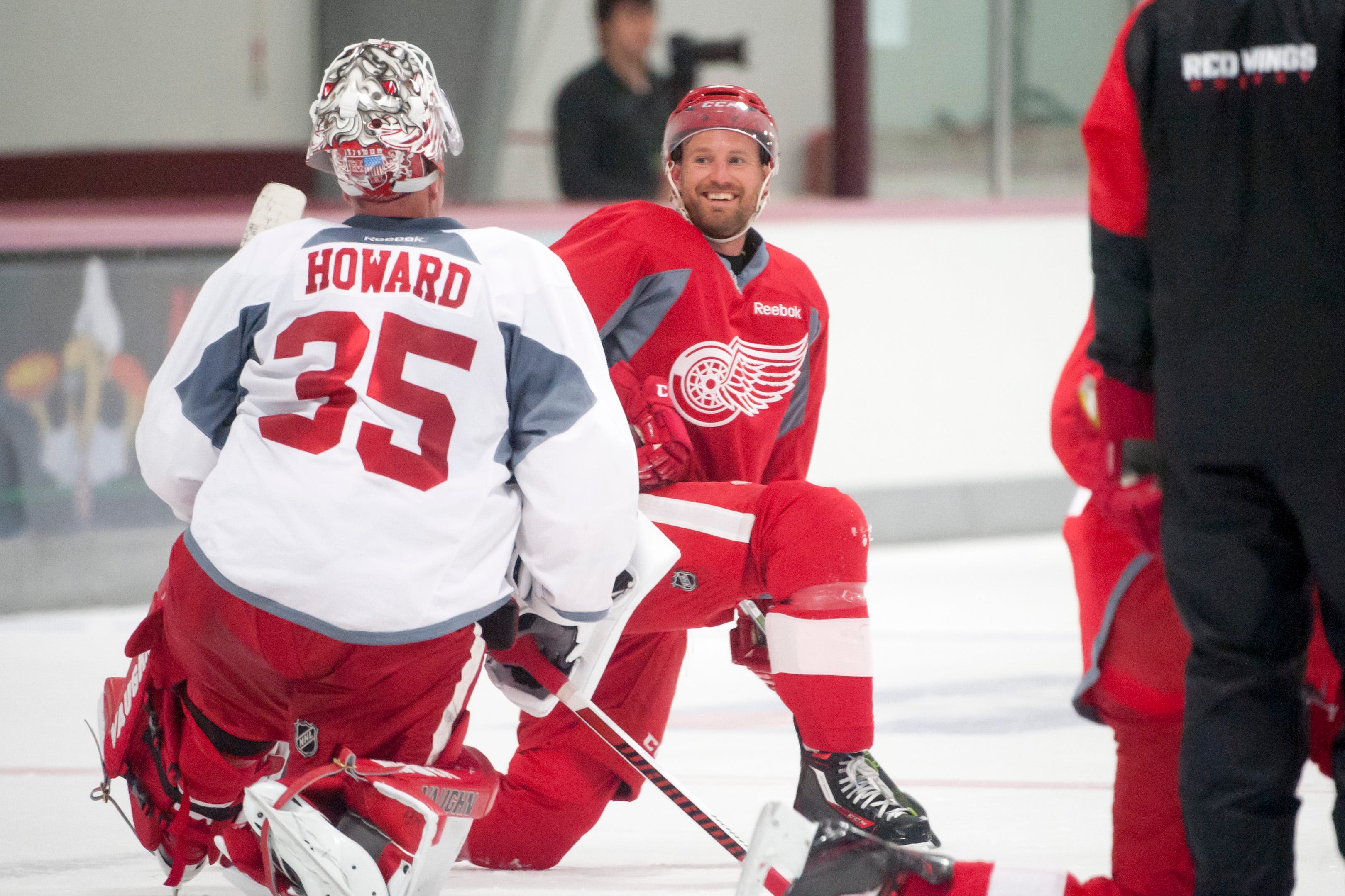 Niklas Kronwall shares a laugh with goalie Jimmy Howard while stretching at training camp at Centre Ice Arena in Traverse City on Sept. 18, 2015.