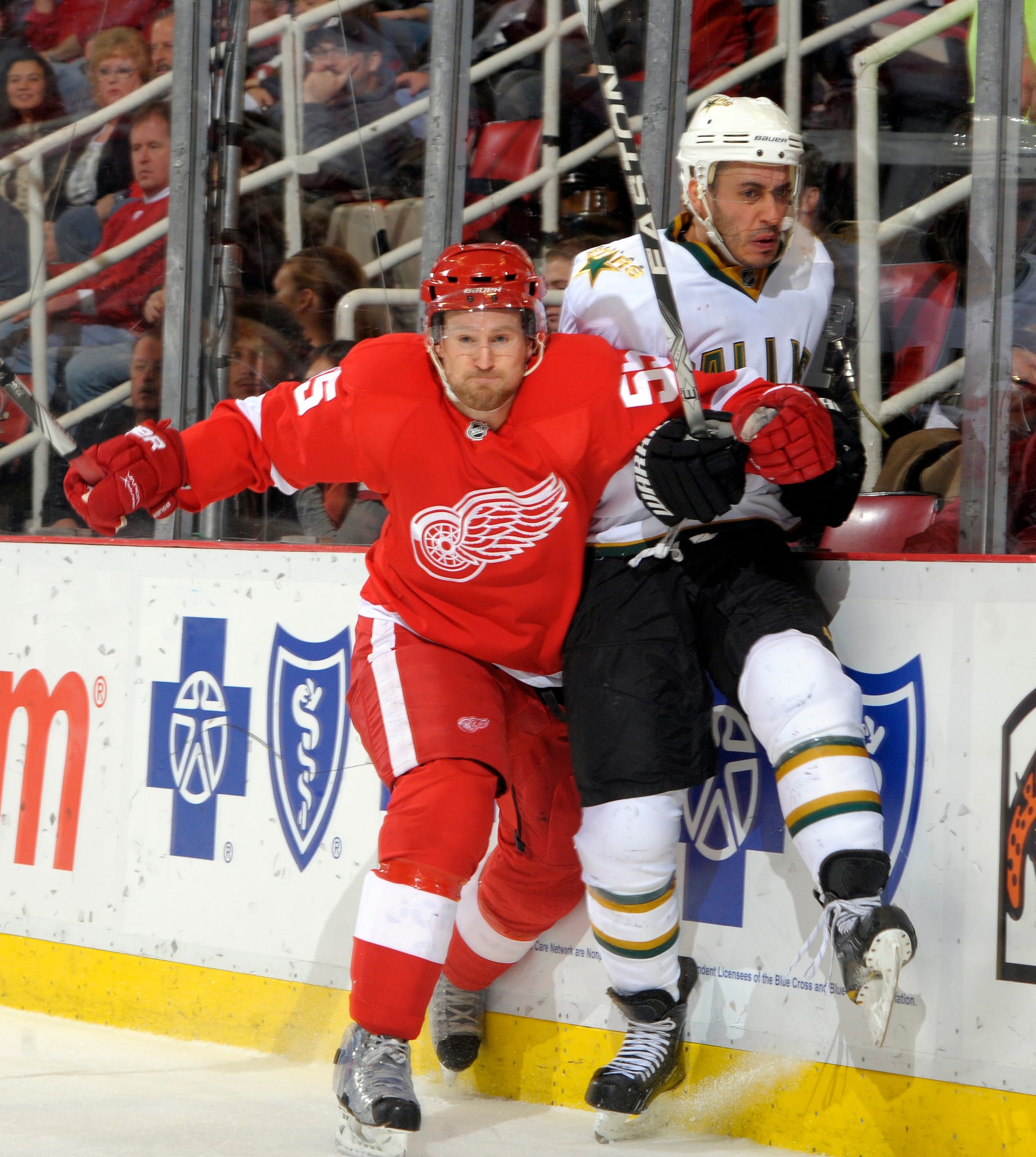 Detroit ' s Niklas Kronwall and Dallas ' Mike Ribeiro collide along the boards during a game at Joe Louis Arena on Dec. 19, 2010.