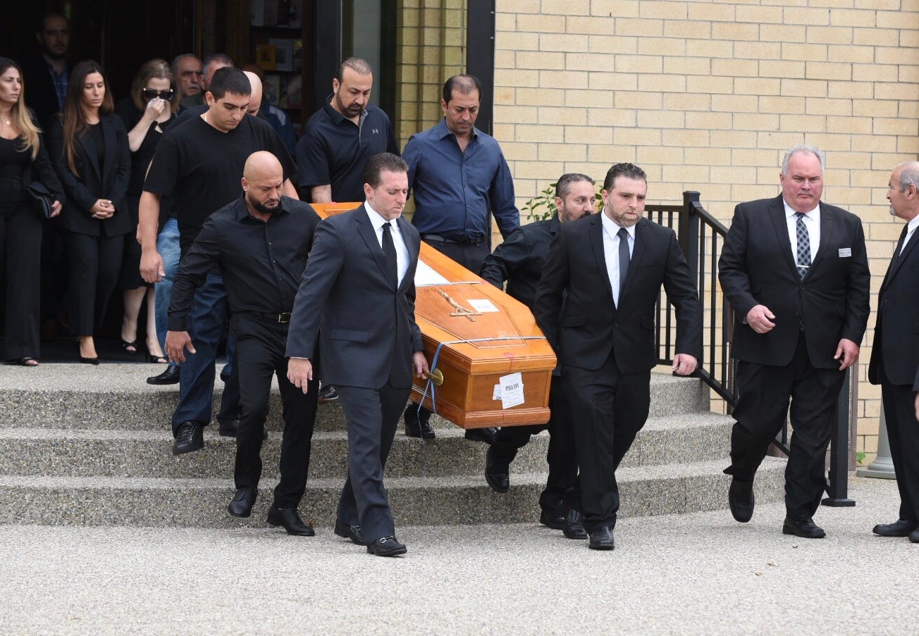 Pallbearers carry the casket of Jimmy Aldaoud, a refugee who died after he was deported to Iraq, after a memorial service Friday at the Mother of God Chaldean Catholic Church in Southfield.
