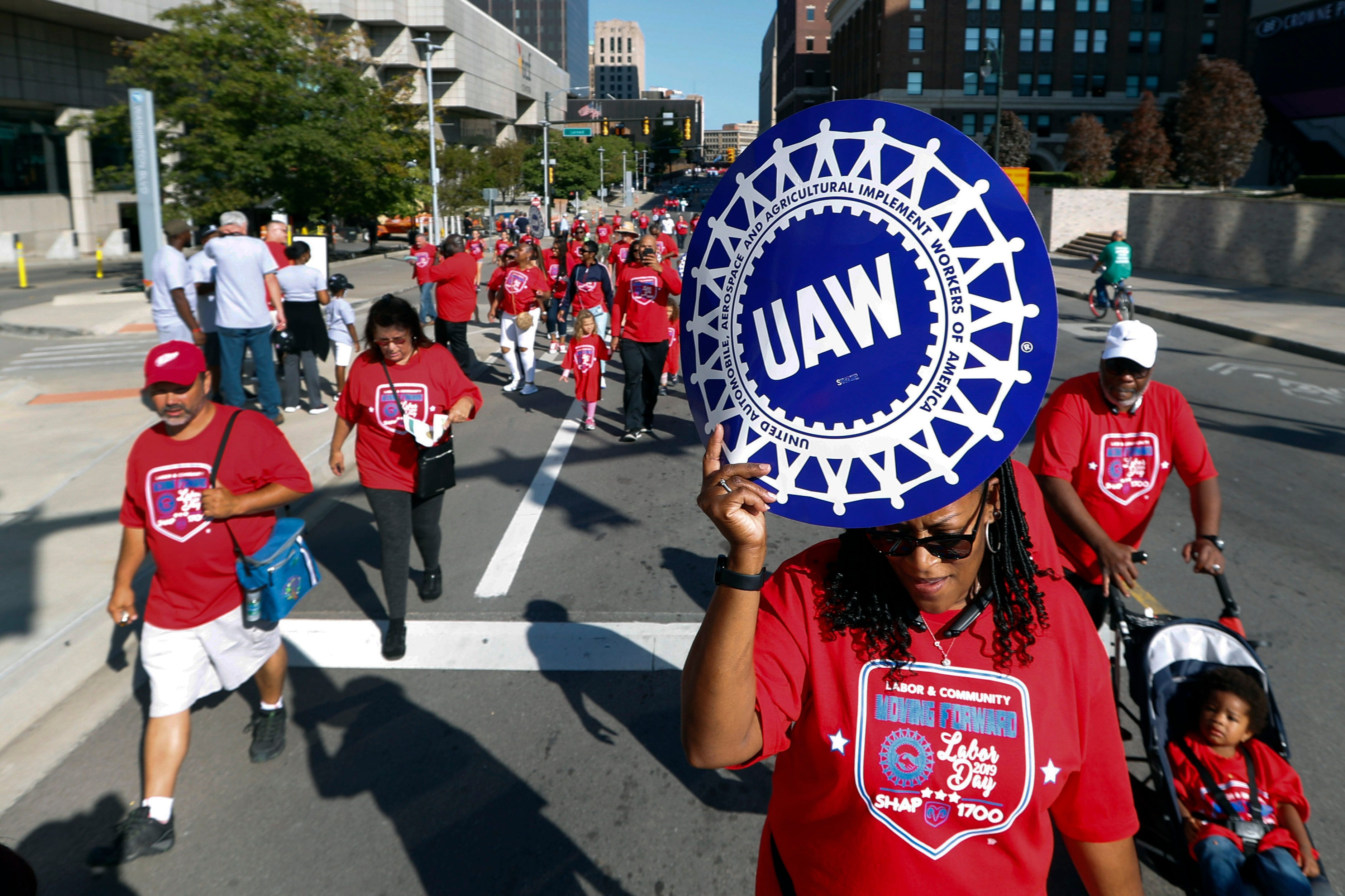 United Auto Workers members walk in the Labor Day parade in Detroit, Monday, Sept. 2, 2019. (AP Photo/Paul Sancya)