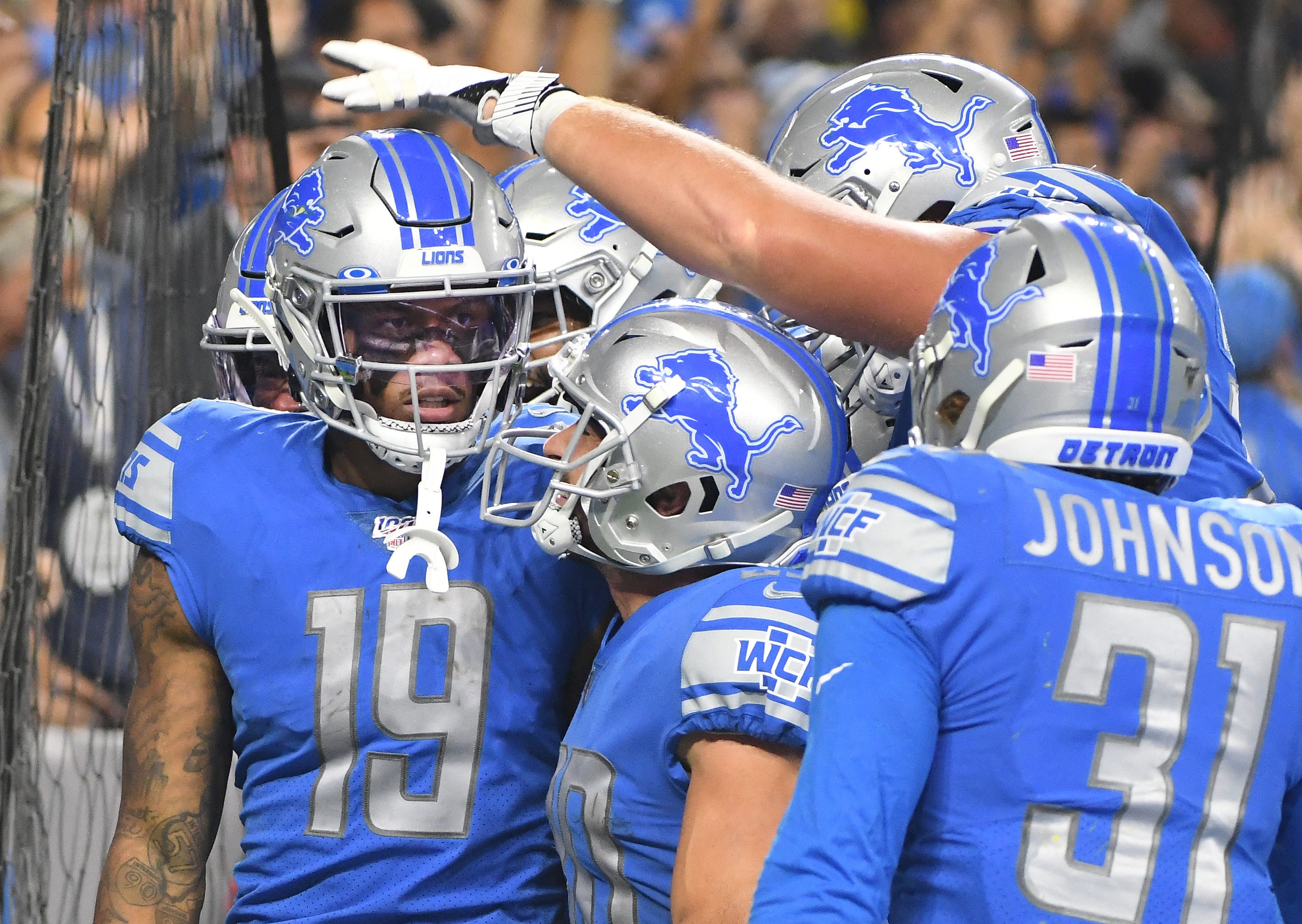 Lions teammates celebrate with Kenny Golladay after his go-ahead touchdown catch in the fourth quarter last Sunday against the Chargers.