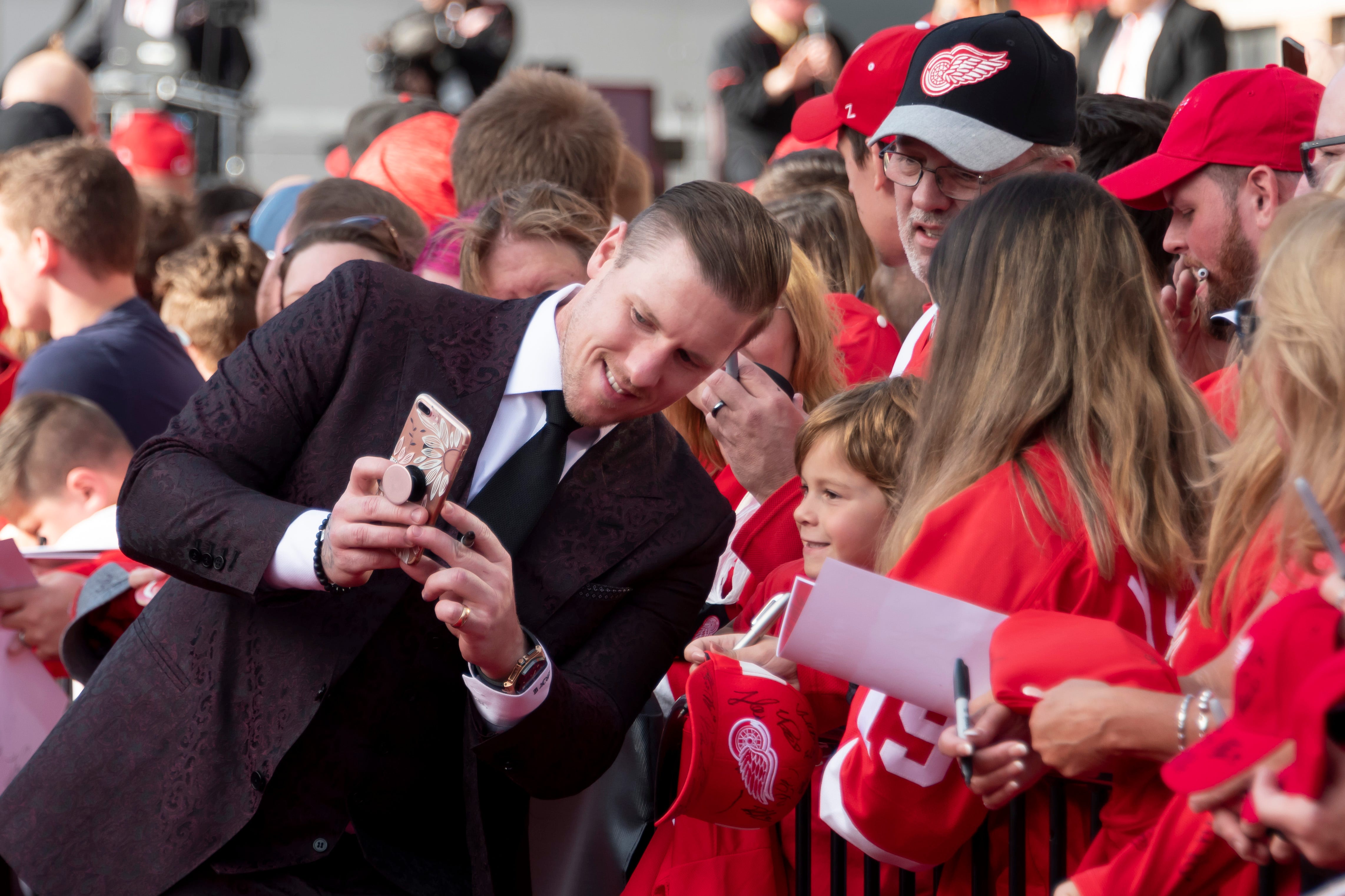 Red Wings goaltender Jimmy Howard poses for photos while participating in a red carpet ceremony before the team's home opener against the Dallas Stars.