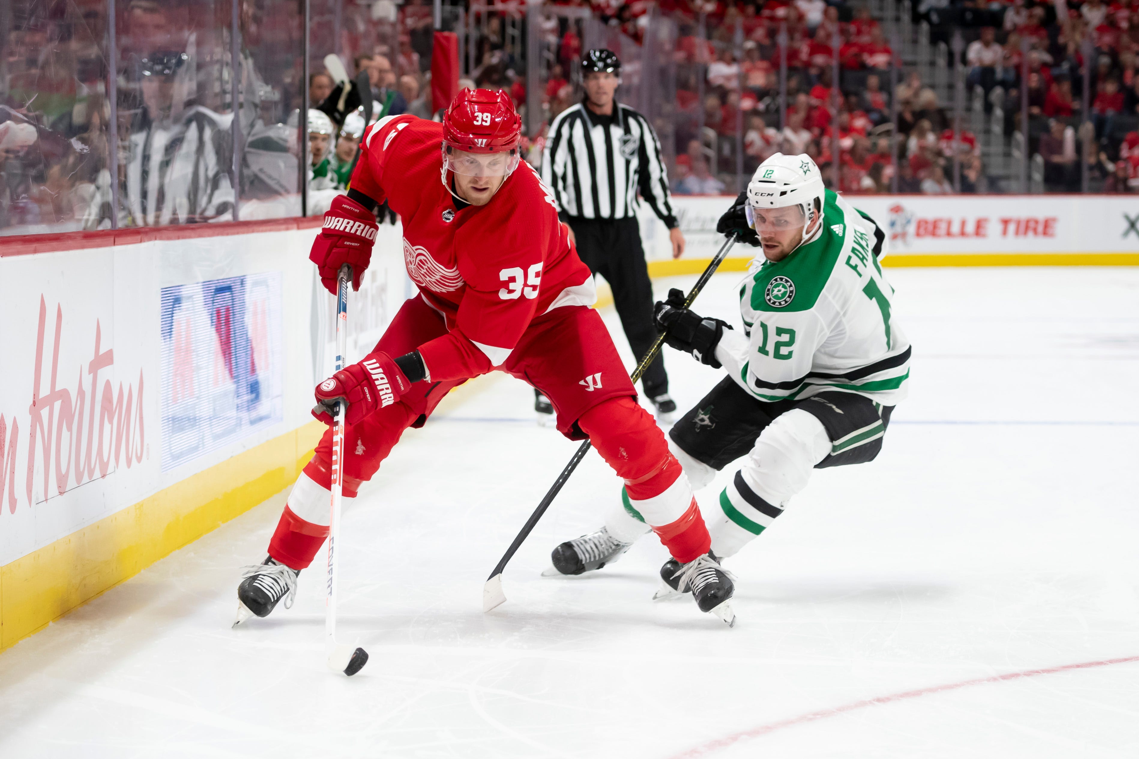 Detroit right wing Anthony Mantha keeps the puck away from Dallas center Radek Faksa in the third period.