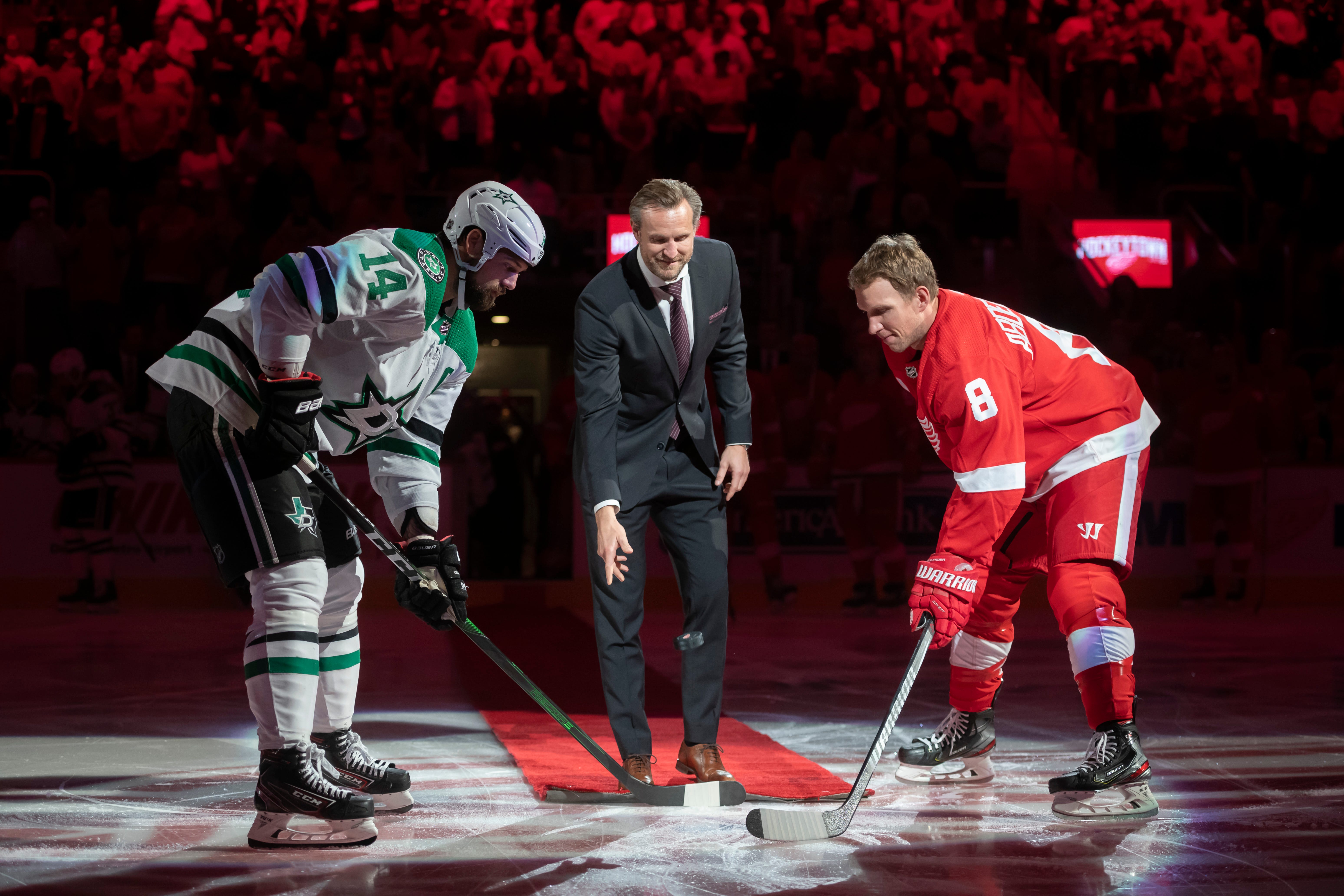 Former Red Wings defenseman Niklas Kronwall participates in a ceremonial puck drop with Dallas left wing Jamie Benn and Detroit left wing Justin Abdelkader before the start of the game.