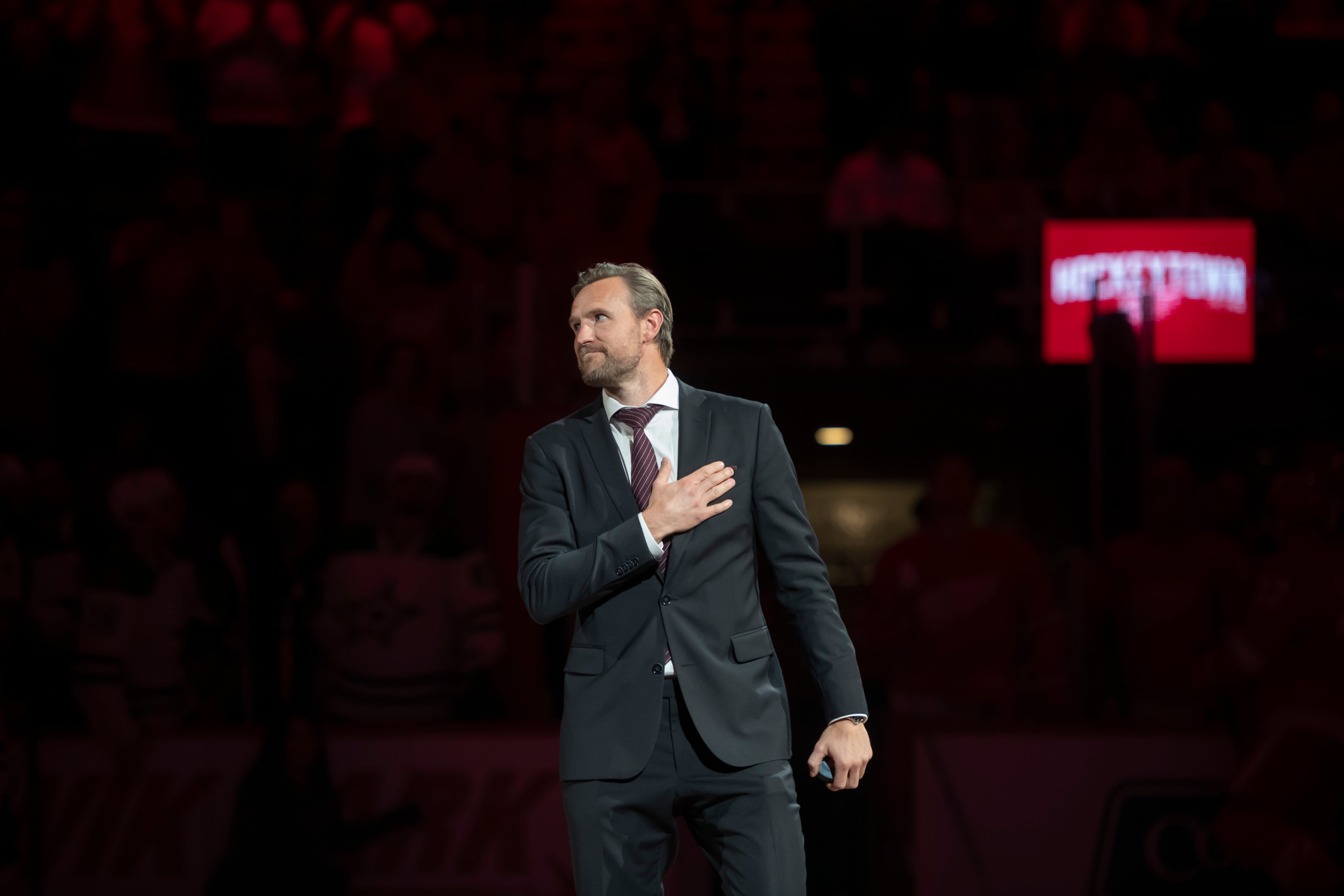 Former Red Wings defenseman Nicklas Kronwall shows his appreciation to the fans while walking onto the ice for a ceremonial puck drop before the start of the game.