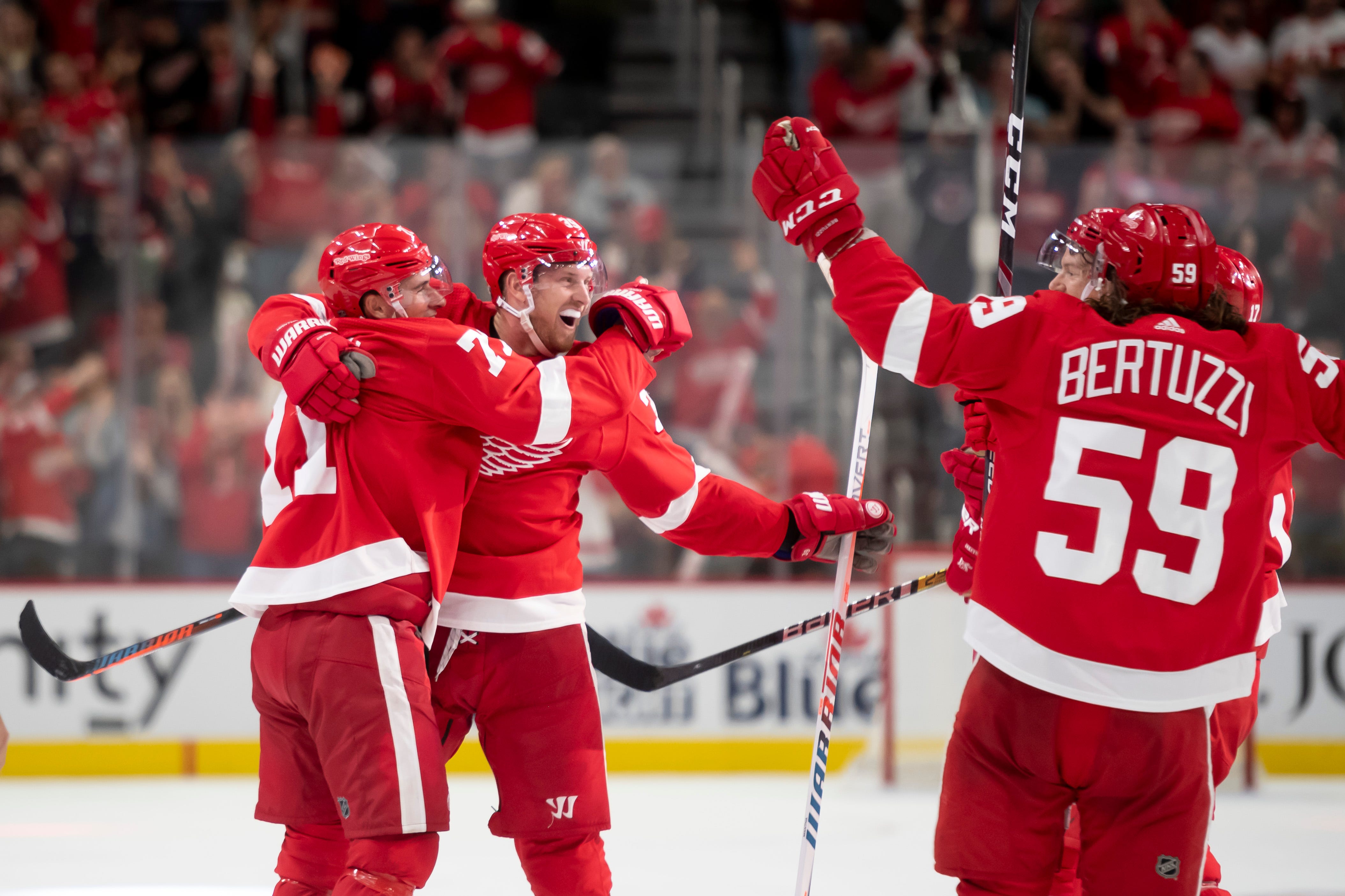 From left, Detroit center Dylan Larkin, right wing Anthony Mantha and the rest of the Red Wings celebrate Mantha's fourth goal of the game in the third period.