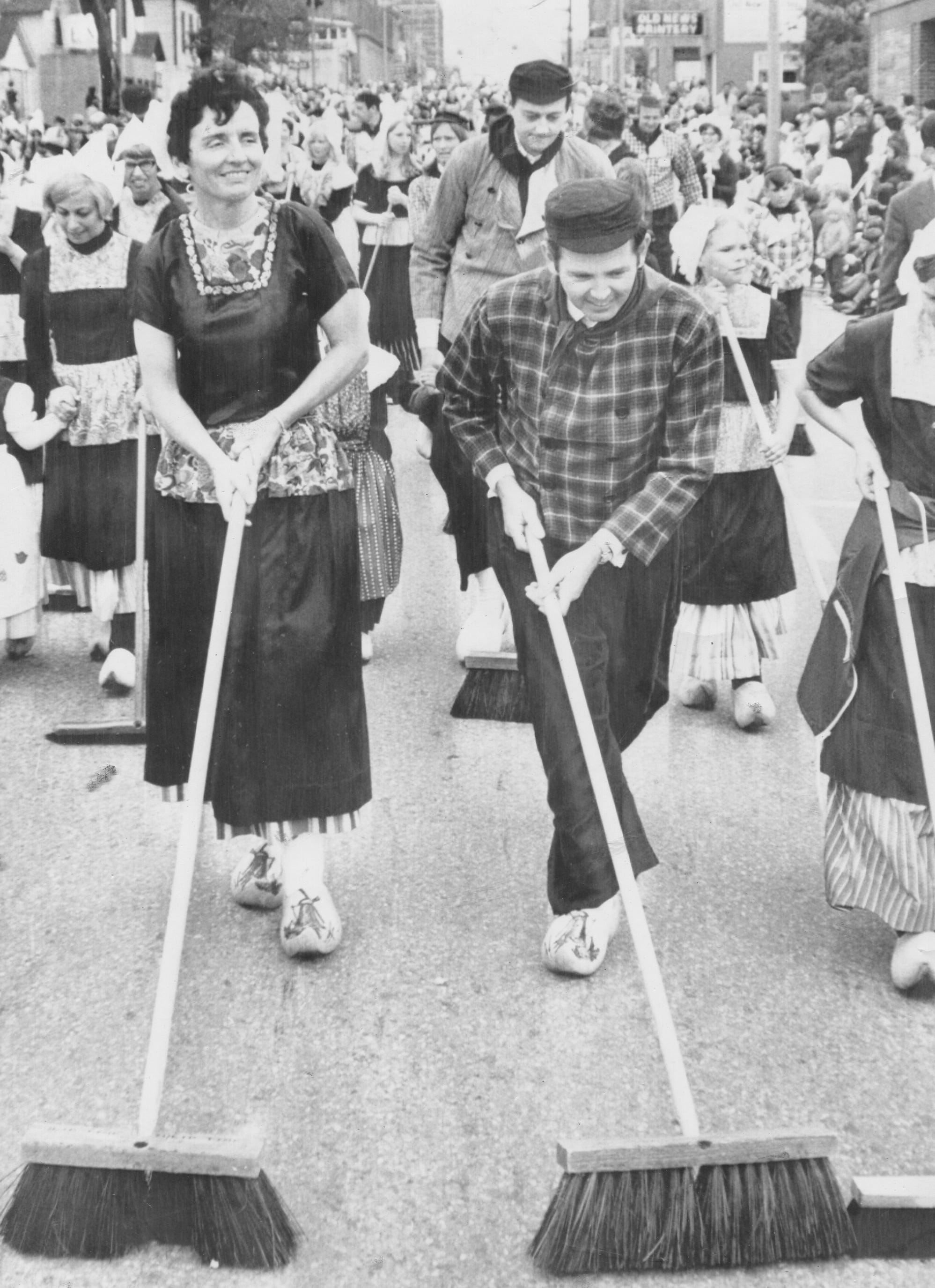The Millikens continue the tradition of Michigan governors dressing in traditional Dutch clothing and sweeping the street at the Tulip Time Festival in Holland, Michigan in 1978.