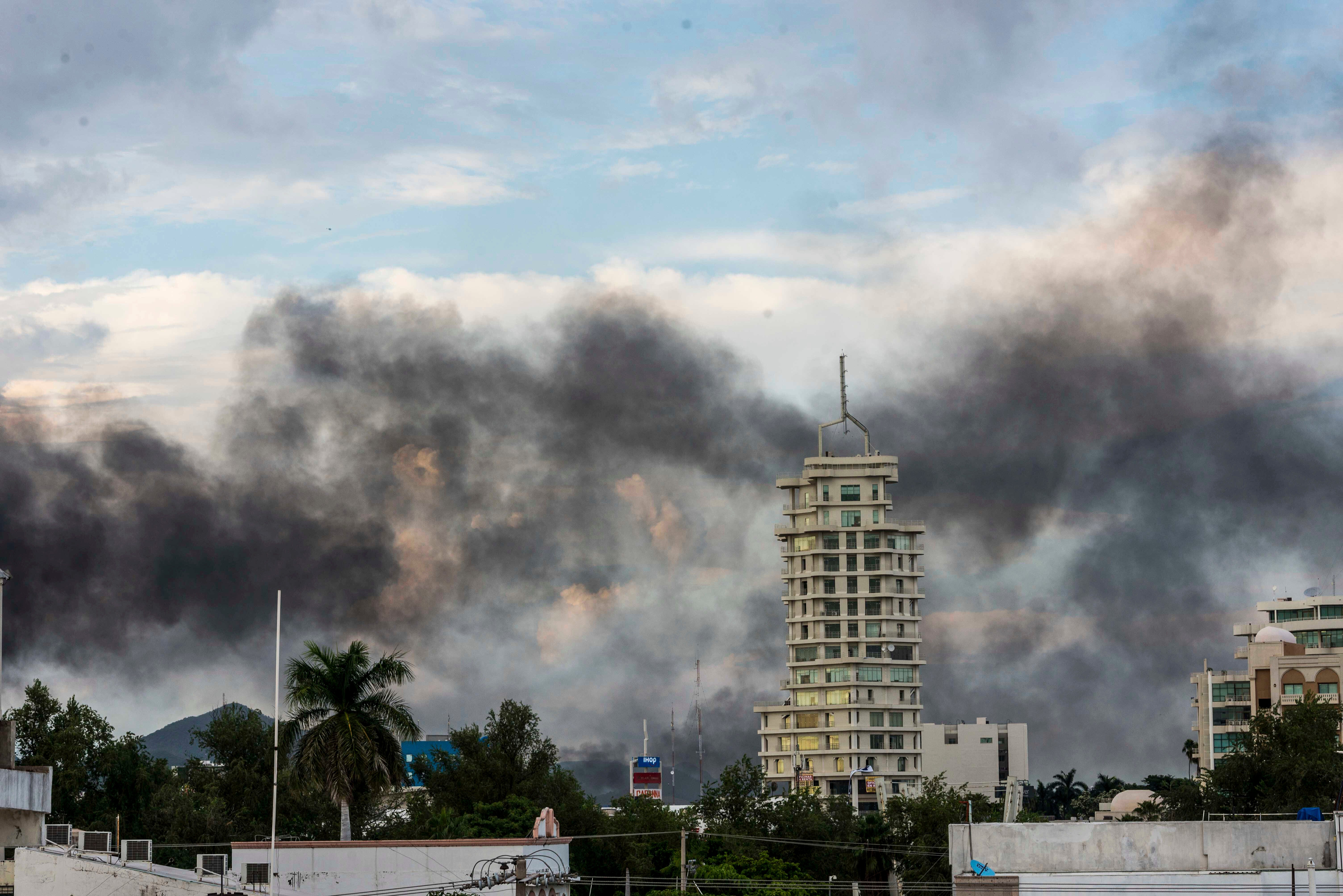 Clouds of smoke from burning cars mar the skyline of Culiacan, Mexico, on Oct. 17. The Mexican city lived under drug cartel terror for 12 hours as gang members forced the government to free a drug lord.