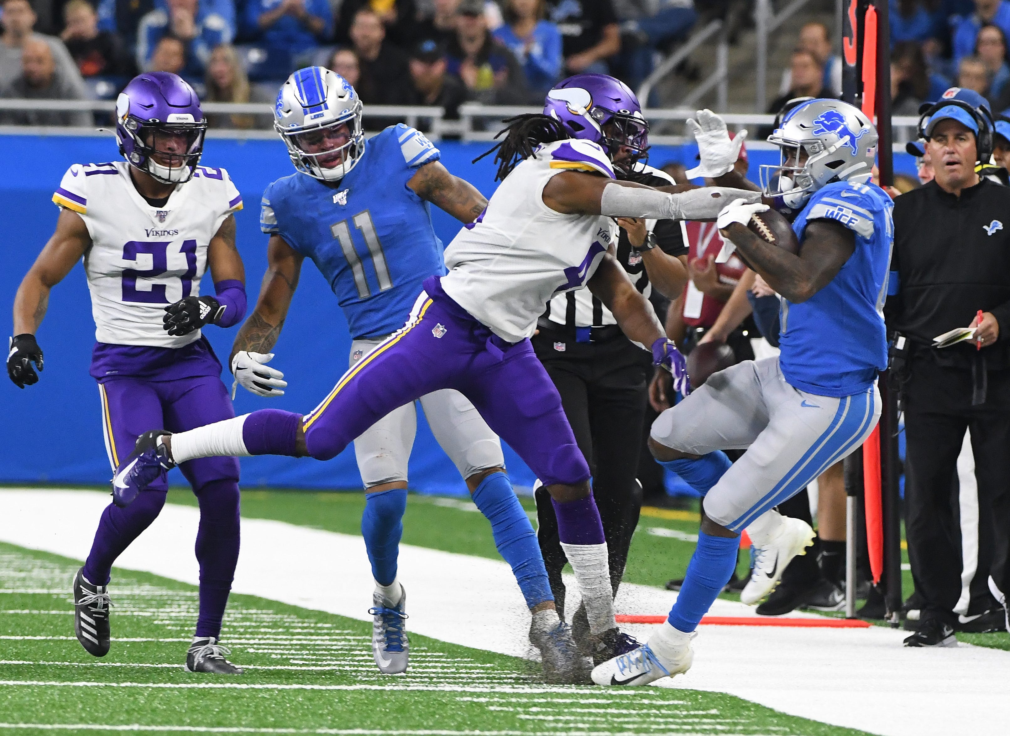 Vikings ' Anthony Harris pushes Lions running back J.D. McKissic out of bounds during a run in the second quarter.