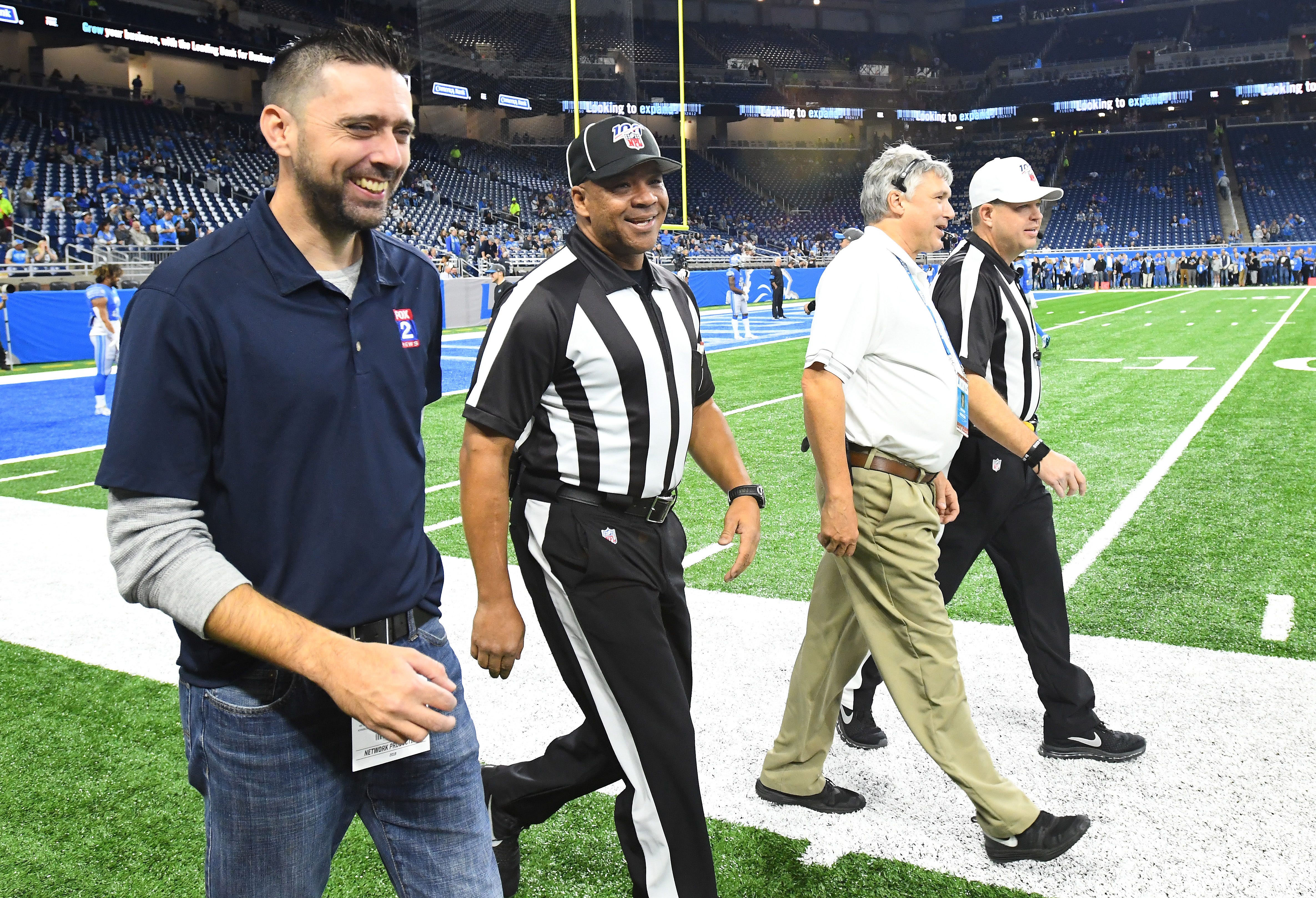 NFL officials break into smiles as the crowd at Ford Field boos the refs, after a controversial call last week that went against Detroit.