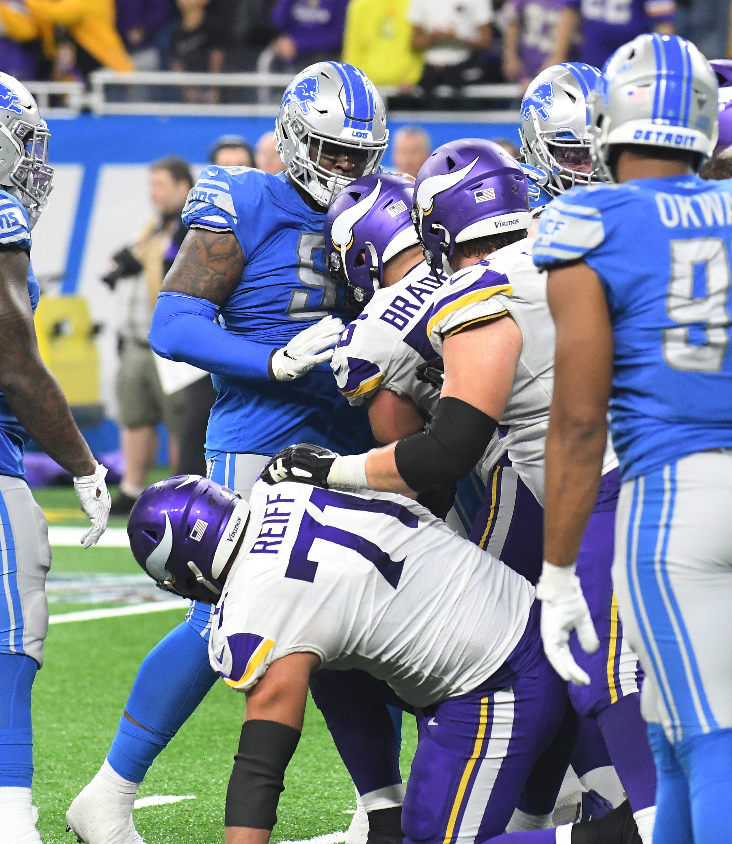 Lions and Vikings players get pushy as Minnesota runs out the clock late in the fourth quarter.