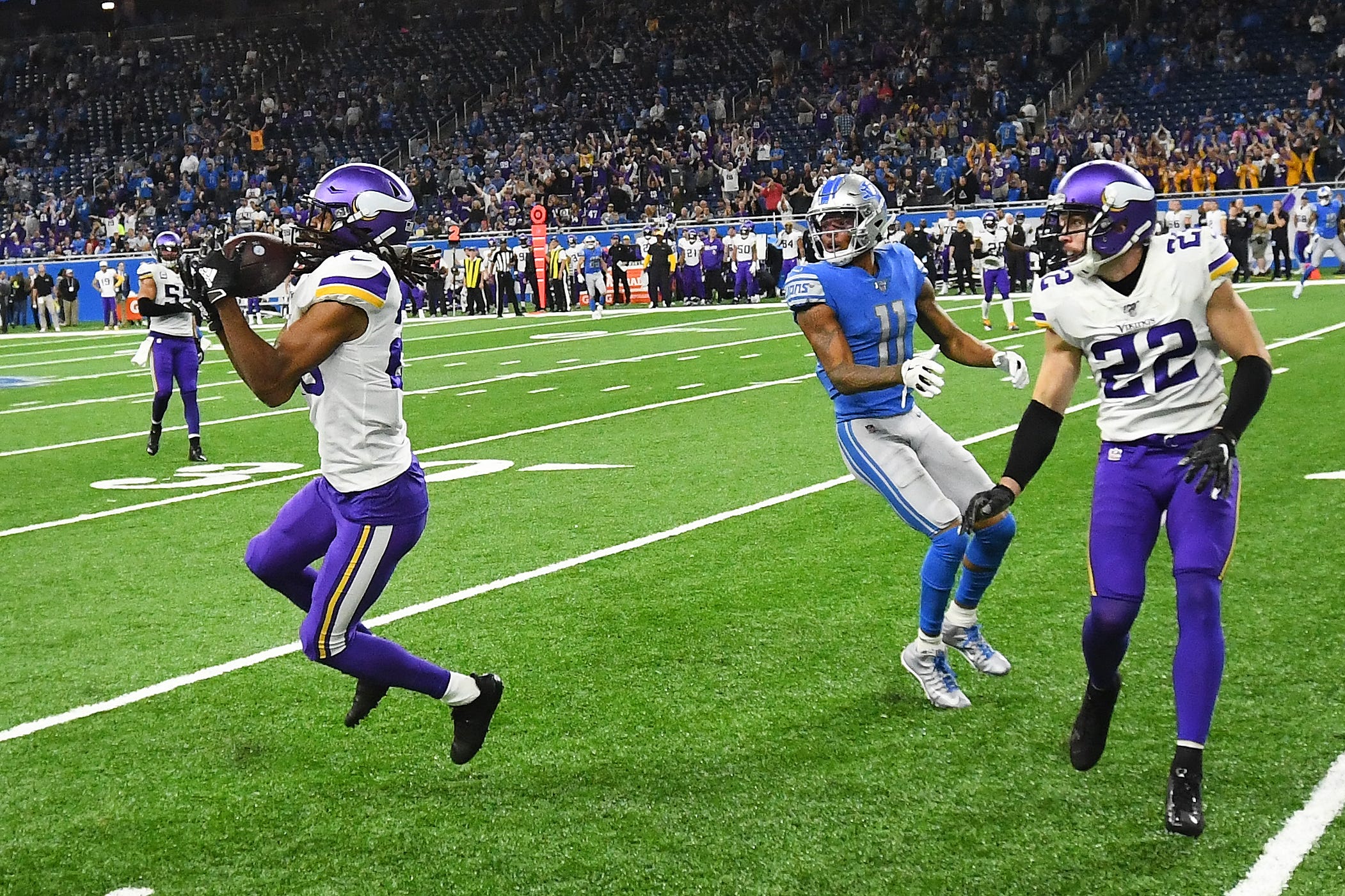 Vikings ' Trae Waynes intercepts a pass intended for Lions ' Marvin Jones late in the fourth quarter.