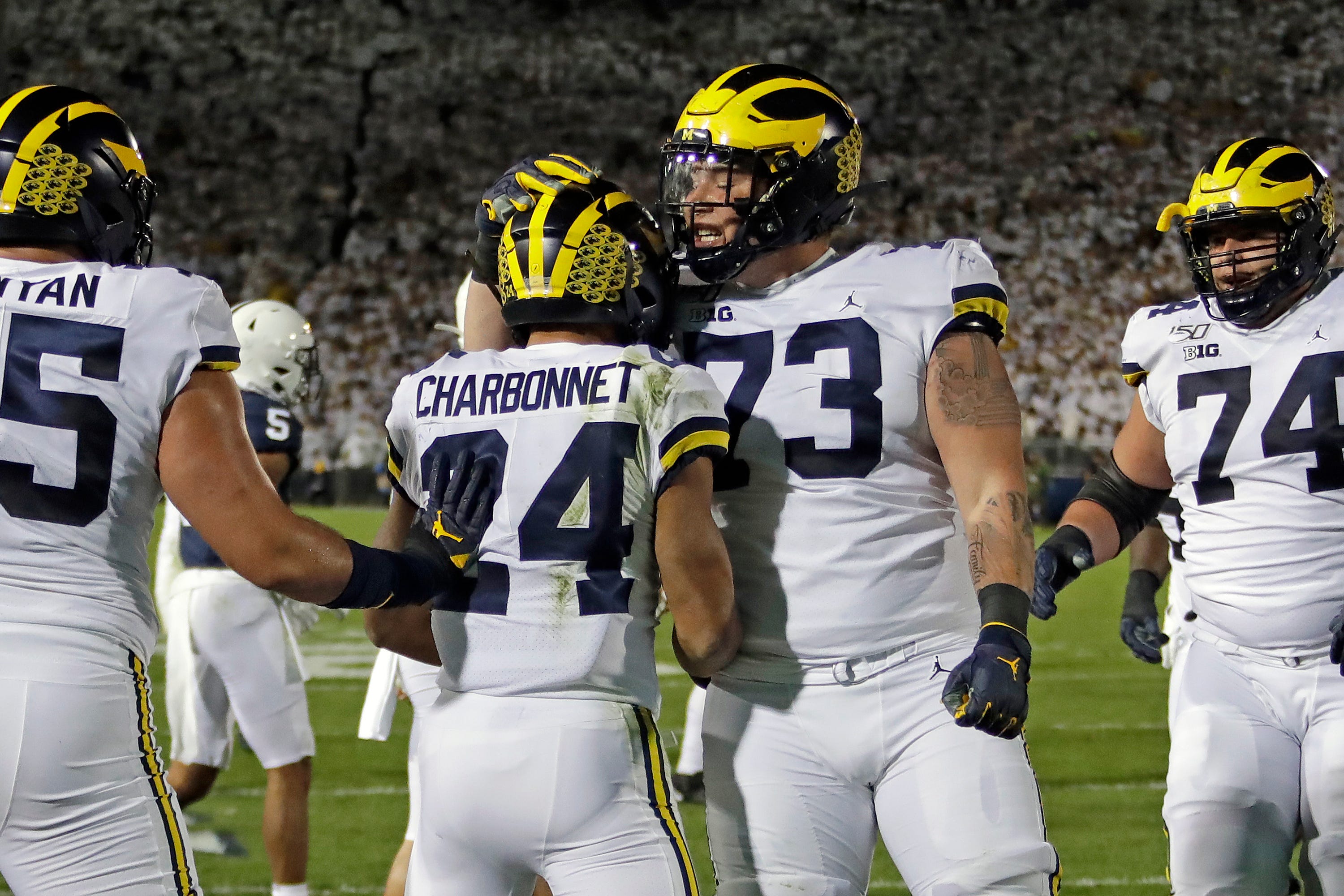 Michigan running back Zach Charbonnet (24) celebrates his touchdown with Jalen Mayfield (73) during the first half.