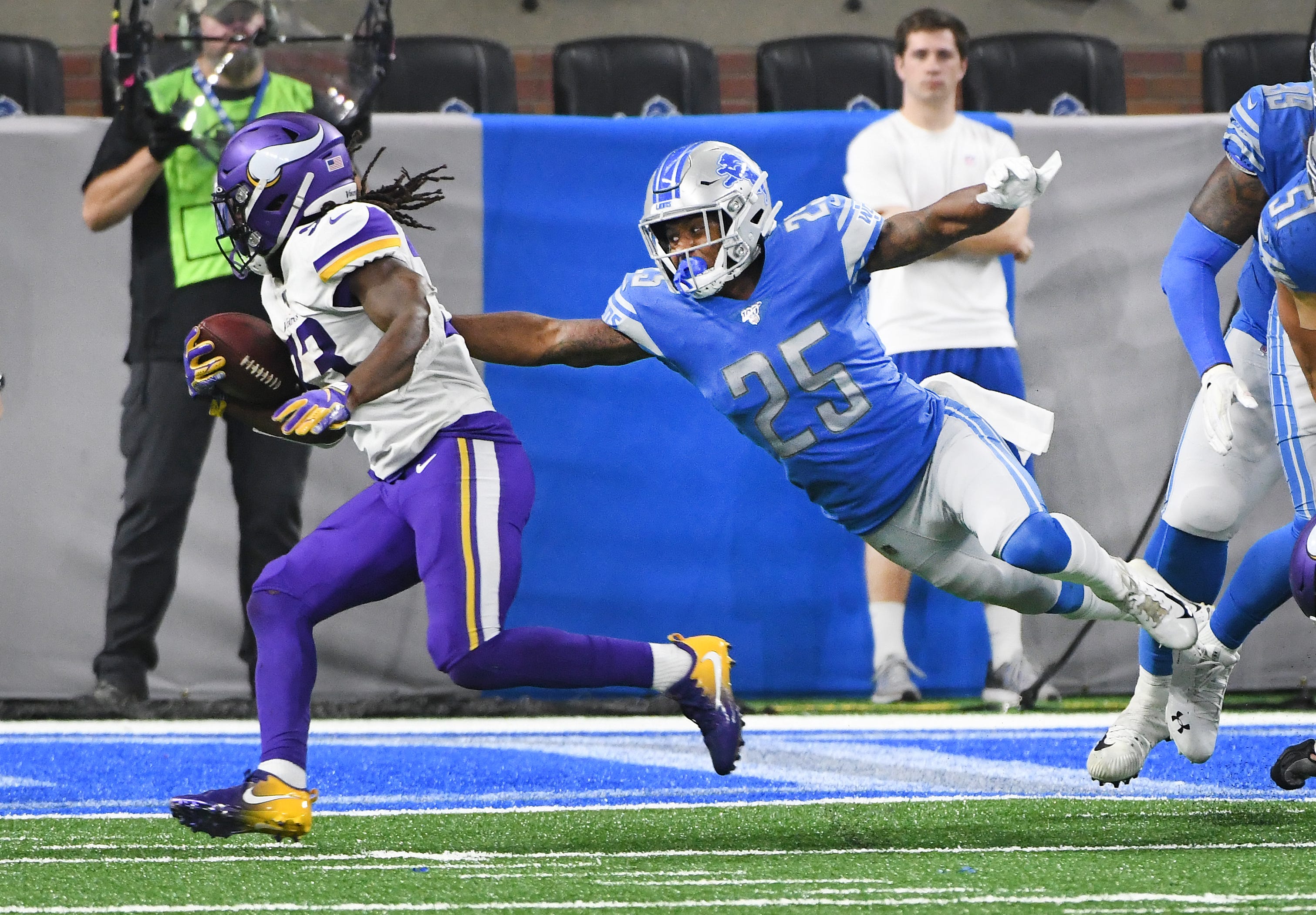 Vikings ' Dalvin Cook leaves Lions ' Will Harris reaching for air as Cook seals the deal with a touchdown late in the fourth quarter.