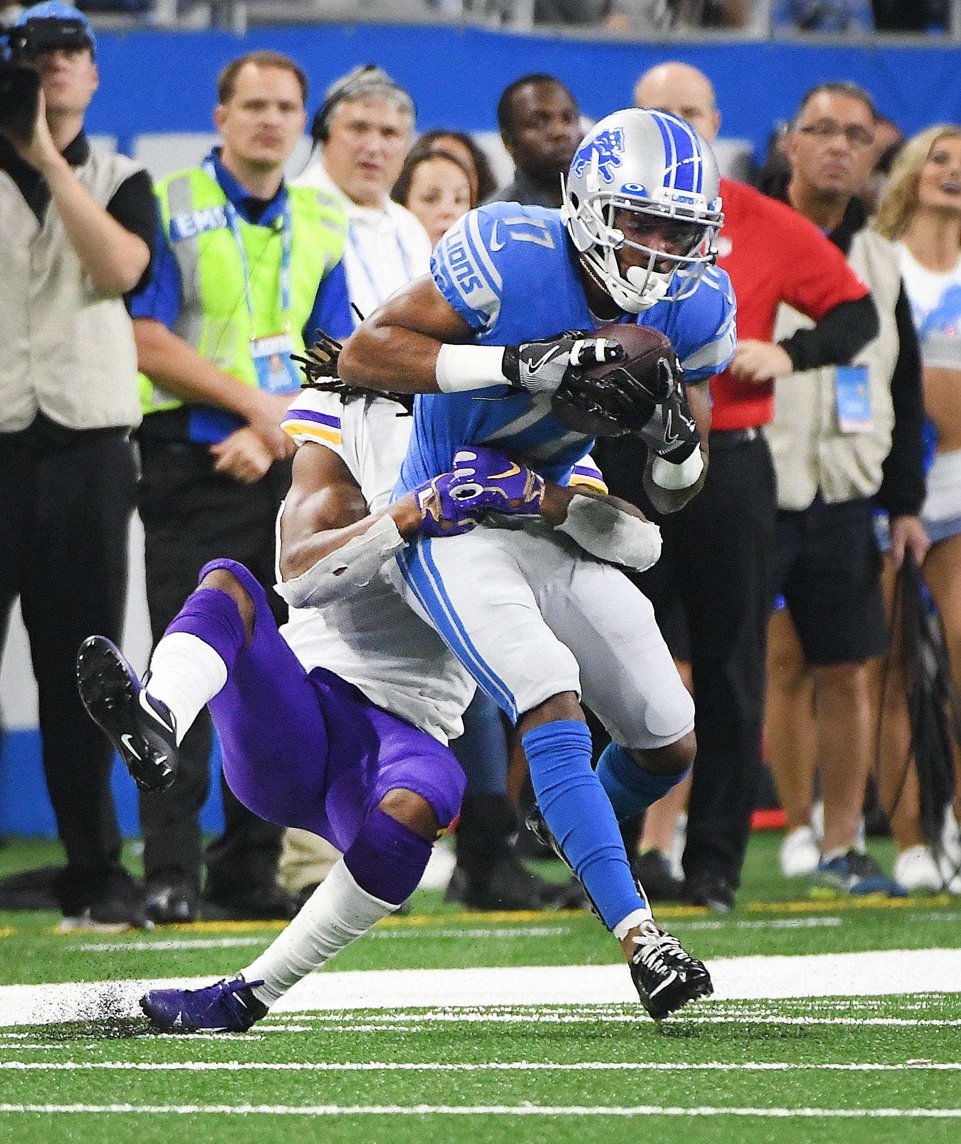 Lions' Marvin Hall is brought down by Vikings' Anthony Harris after a reception in the third quarter.