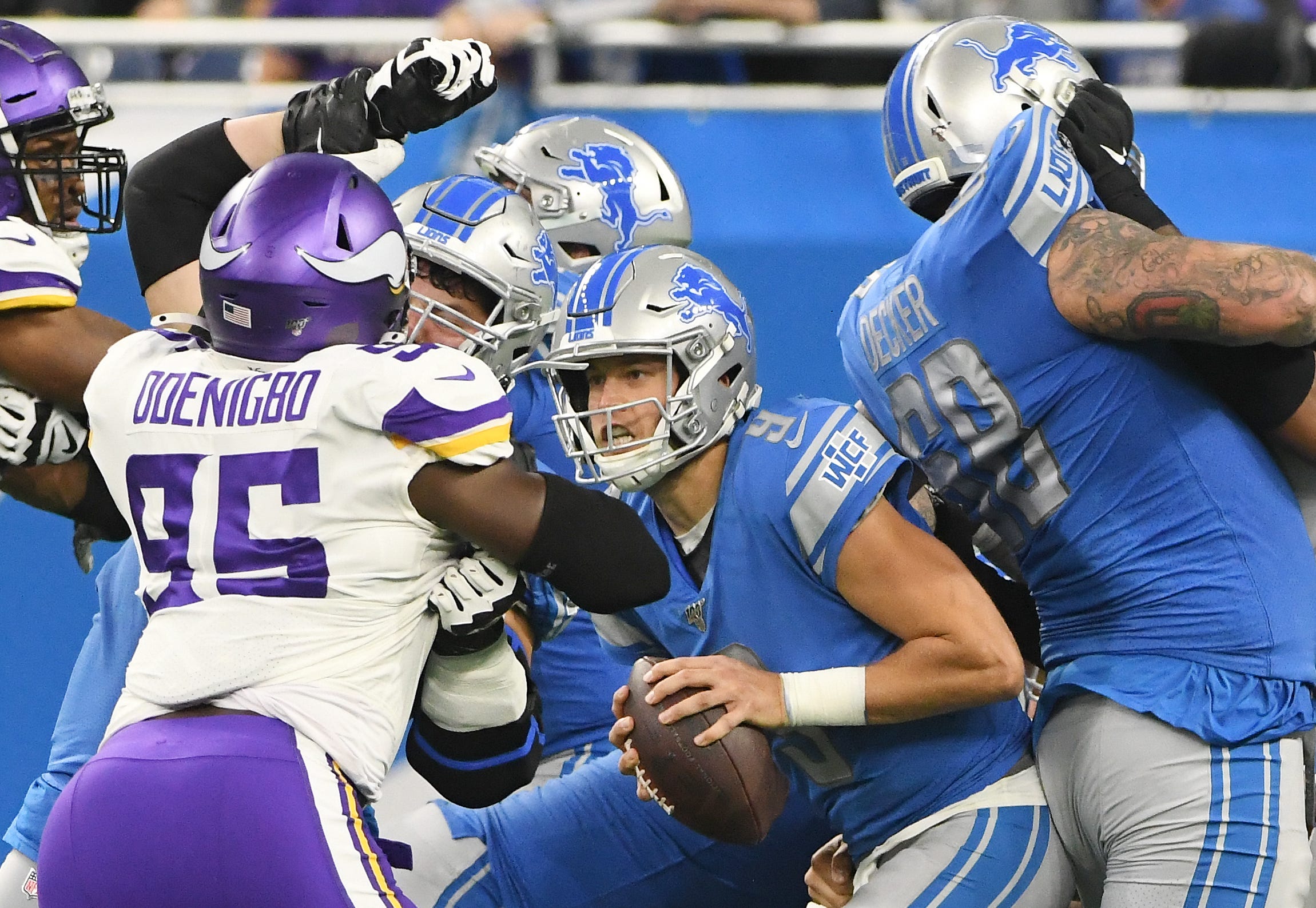 Lions quarterback Matthew Stafford sees the pocket collapsing around him and looks for an exit in the third quarter.