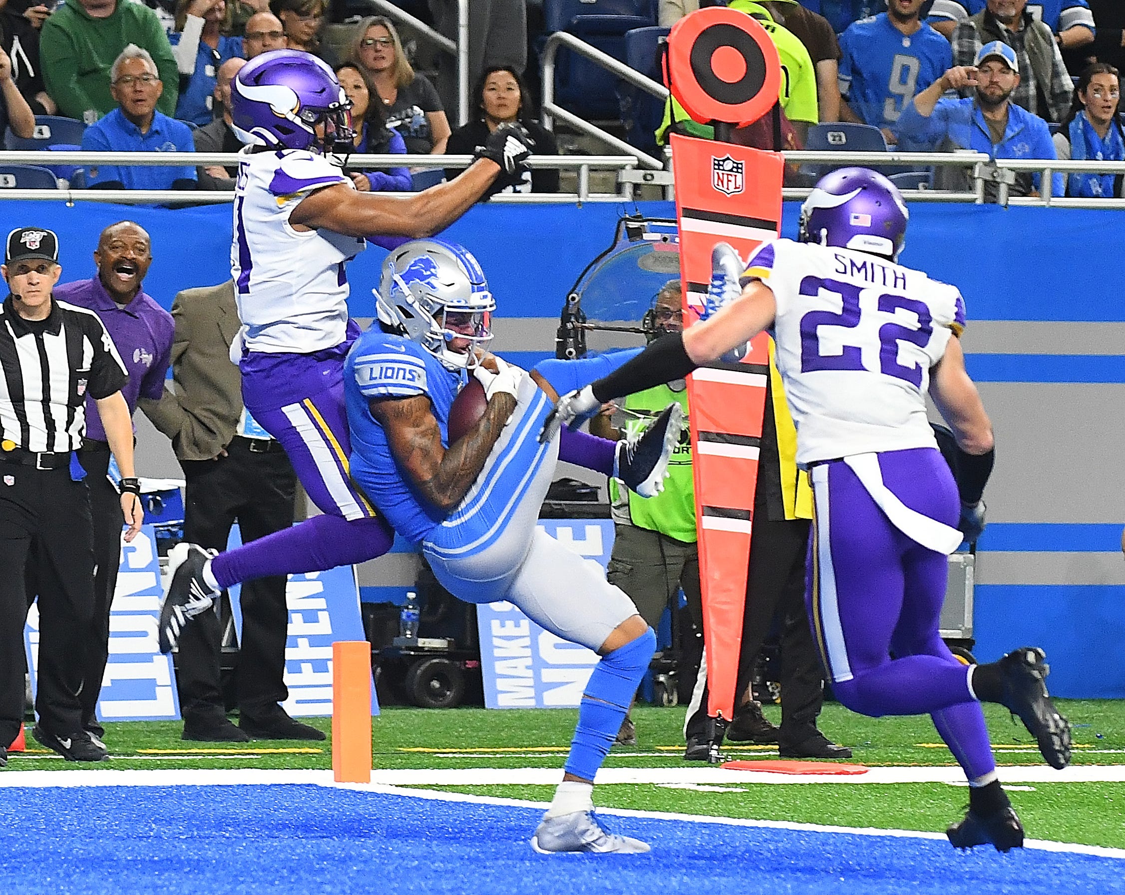 Lions receiver Marvin Jones completes his third touchdown reception, this one in the second quarter, in front of Vikings ' Mike Hughes.