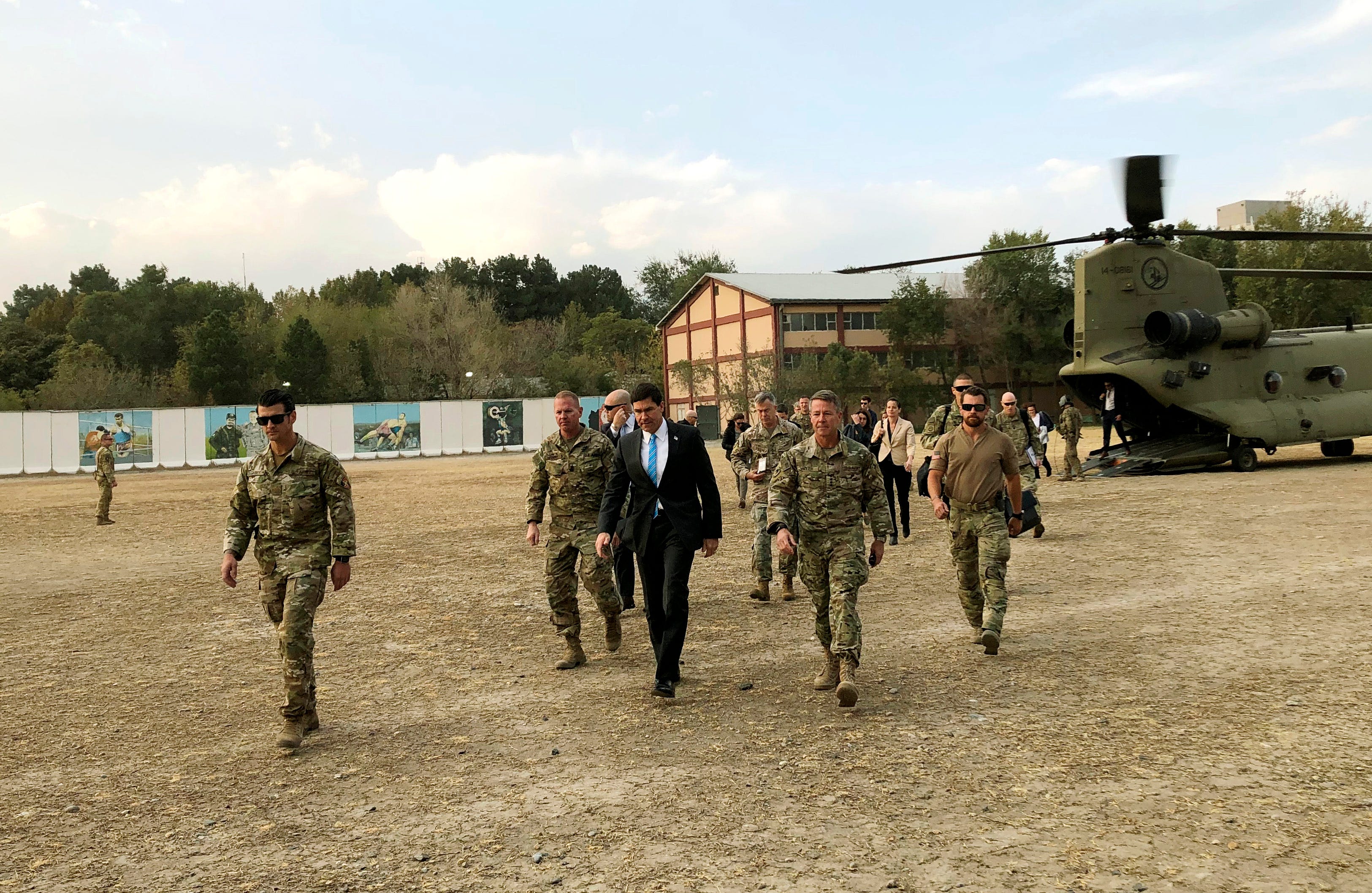 U.S. Defense Secretary Mark Esper, center, walks with Gen. Scott Miller, right, chief of the U.S.-led coalition in Afghanistan, at the U.S. military headquarters in Kabul, Afghanistan, Sunday.