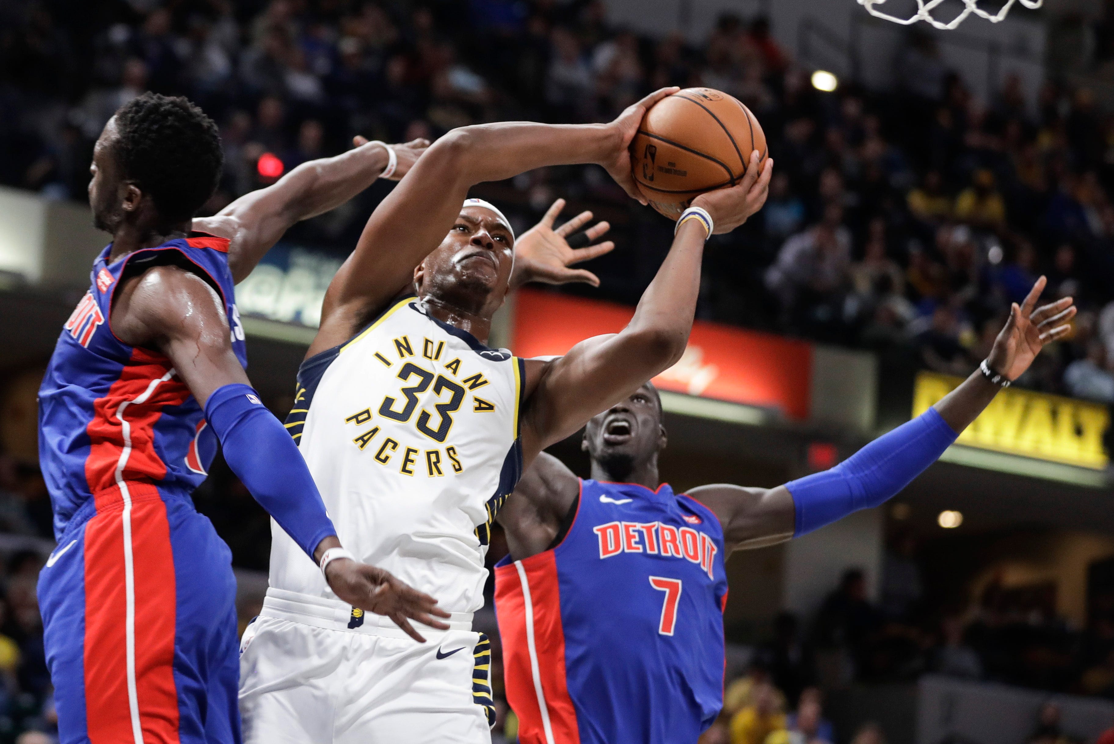 Indiana Pacers' Myles Turner (33) shoots as Detroit Pistons' Reggie Jackson, left, and Thon Maker (7) defend during the second half.