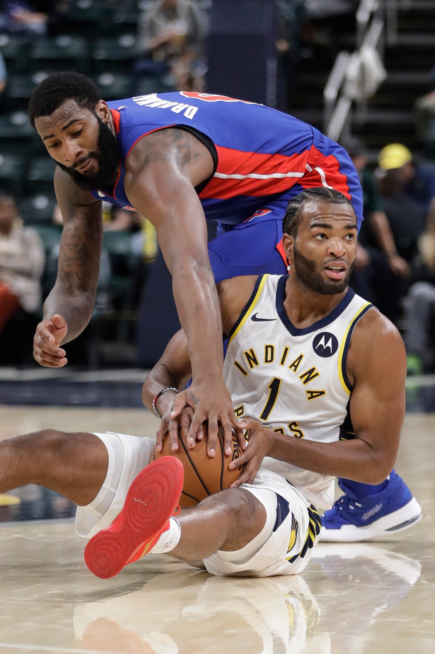 Indiana Pacers ' T.J. Warren (1) is defended by Detroit Pistons ' Andre Drummond during the second half.