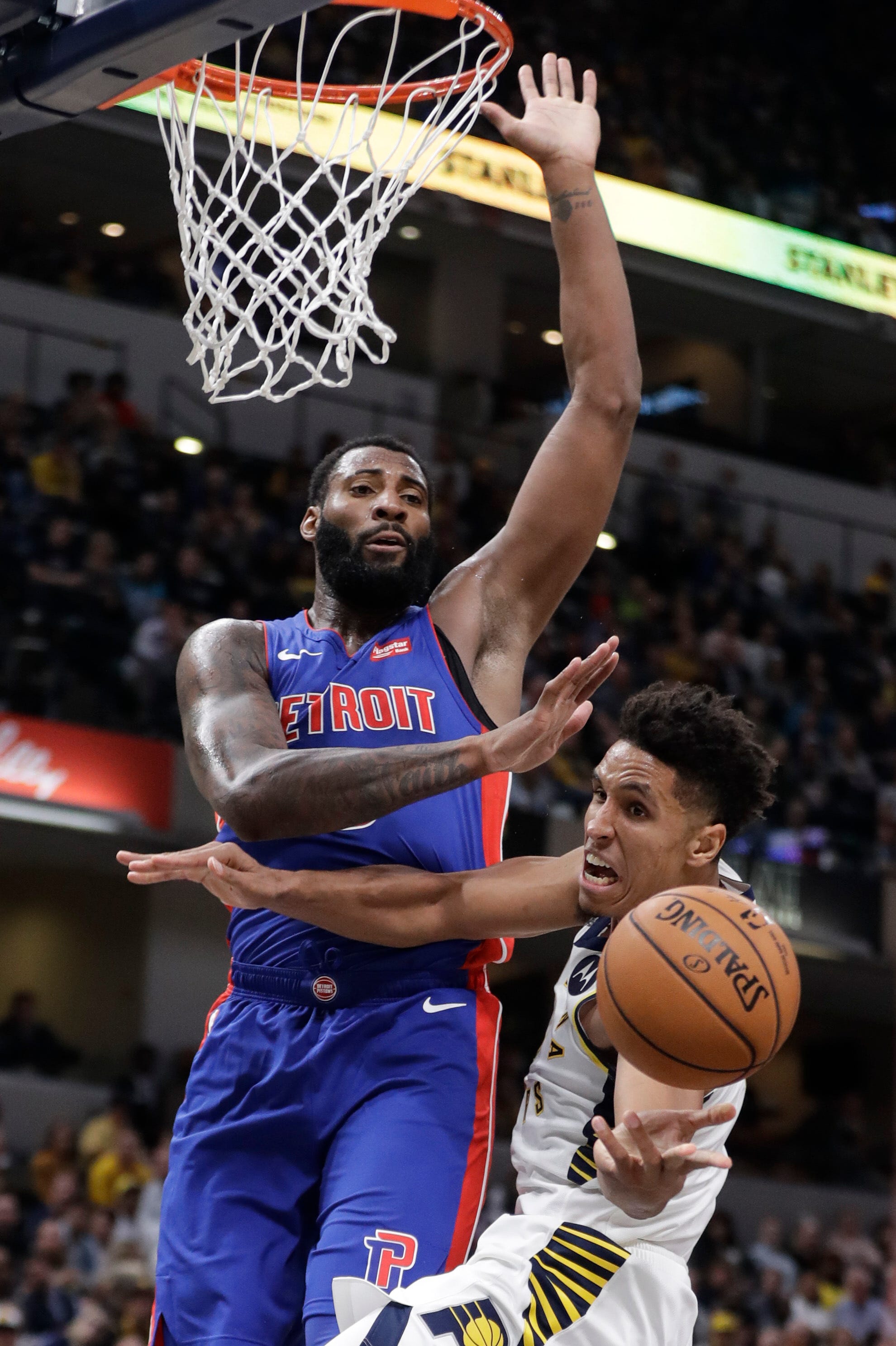 Indiana Pacers ' Malcolm Brogdon, right, is fouled by Detroit Pistons ' Andre Drummond during the second half.