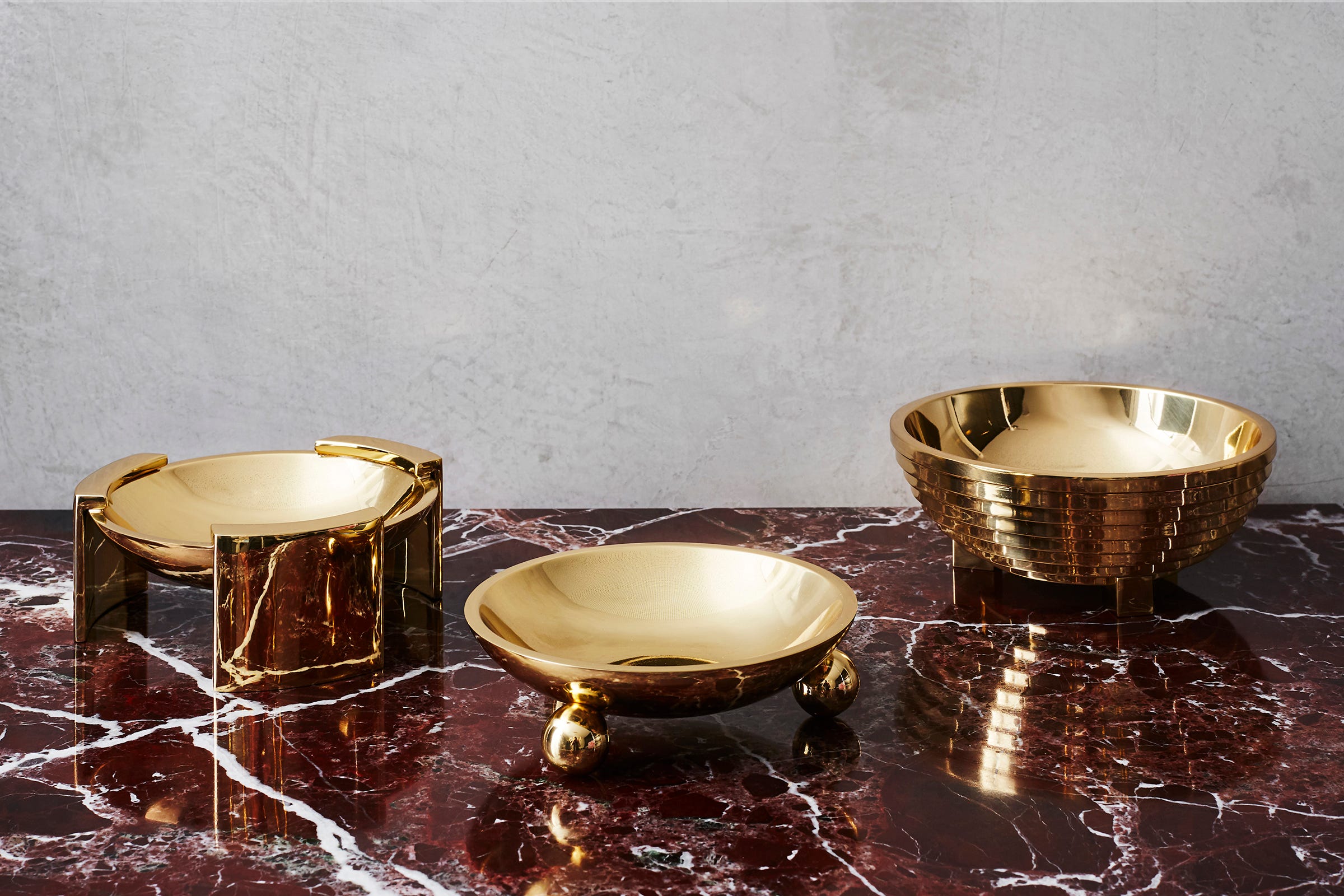 Hand-cast and hand-polished brass bowls add a layer of elegance, says Natale. From left to right: Boule, Trident (on wide legs) and Ziggurat, from his collection. They are lacquered to preserve their luster.