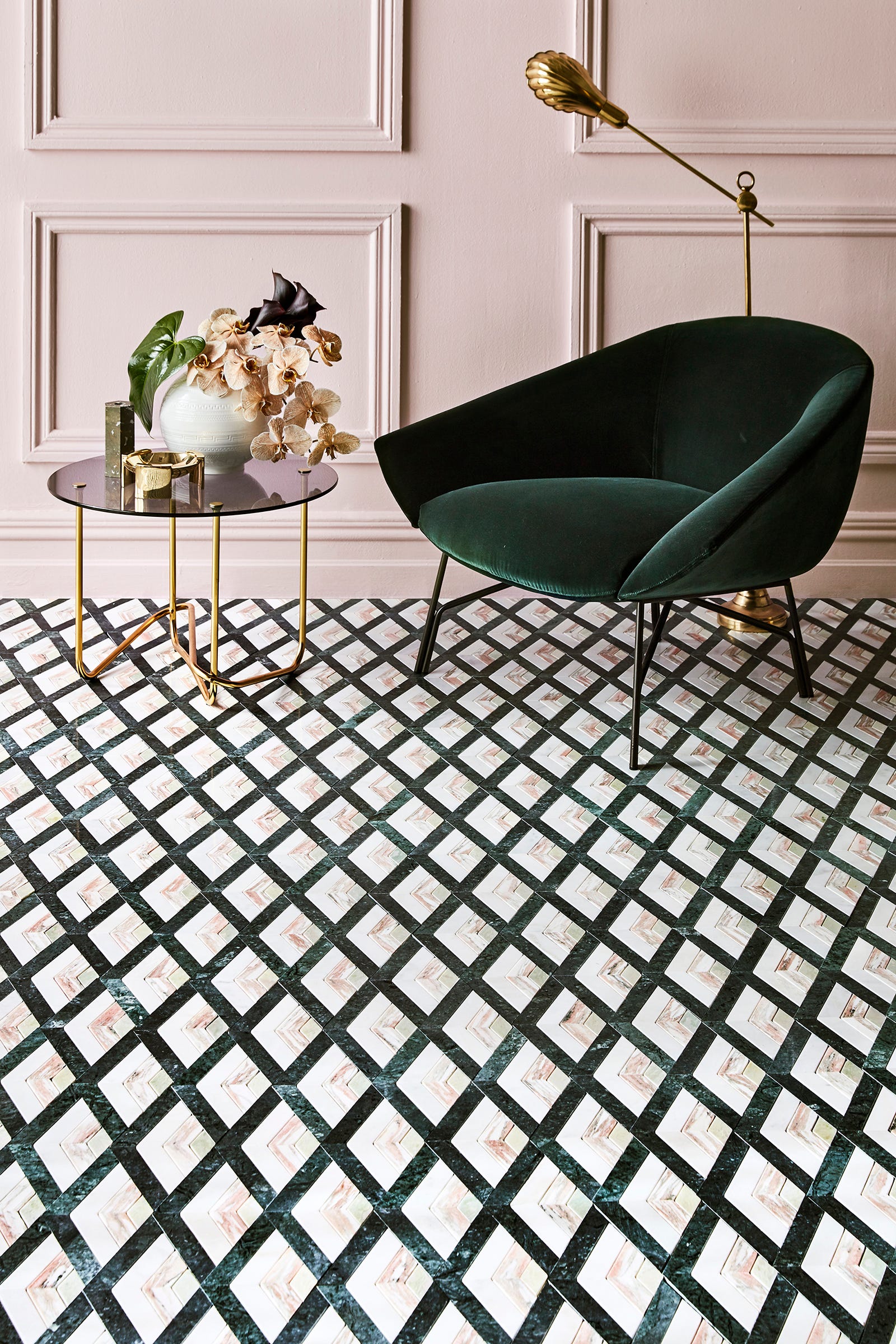 The diagonal pattern created by Natale's graphic Moscow honed marble tiles in Norwegian rose, Carrara Gioia and emerald green creates a dynamic ground for classic paneled walls, painted in a soft blush.