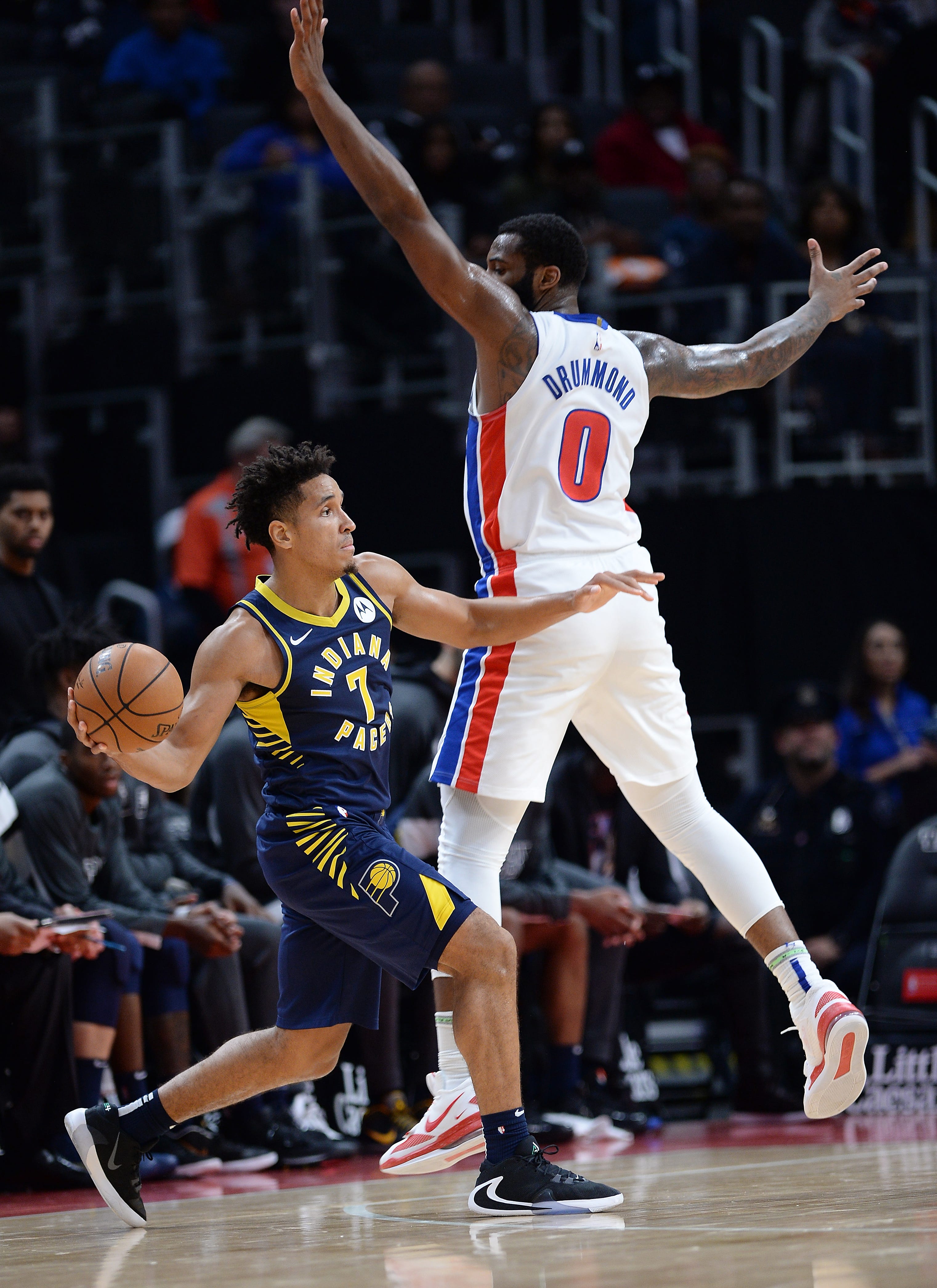 Pistons' Andre Drummond defends the Pacers' Malcolm Brogdon in the first quarter.