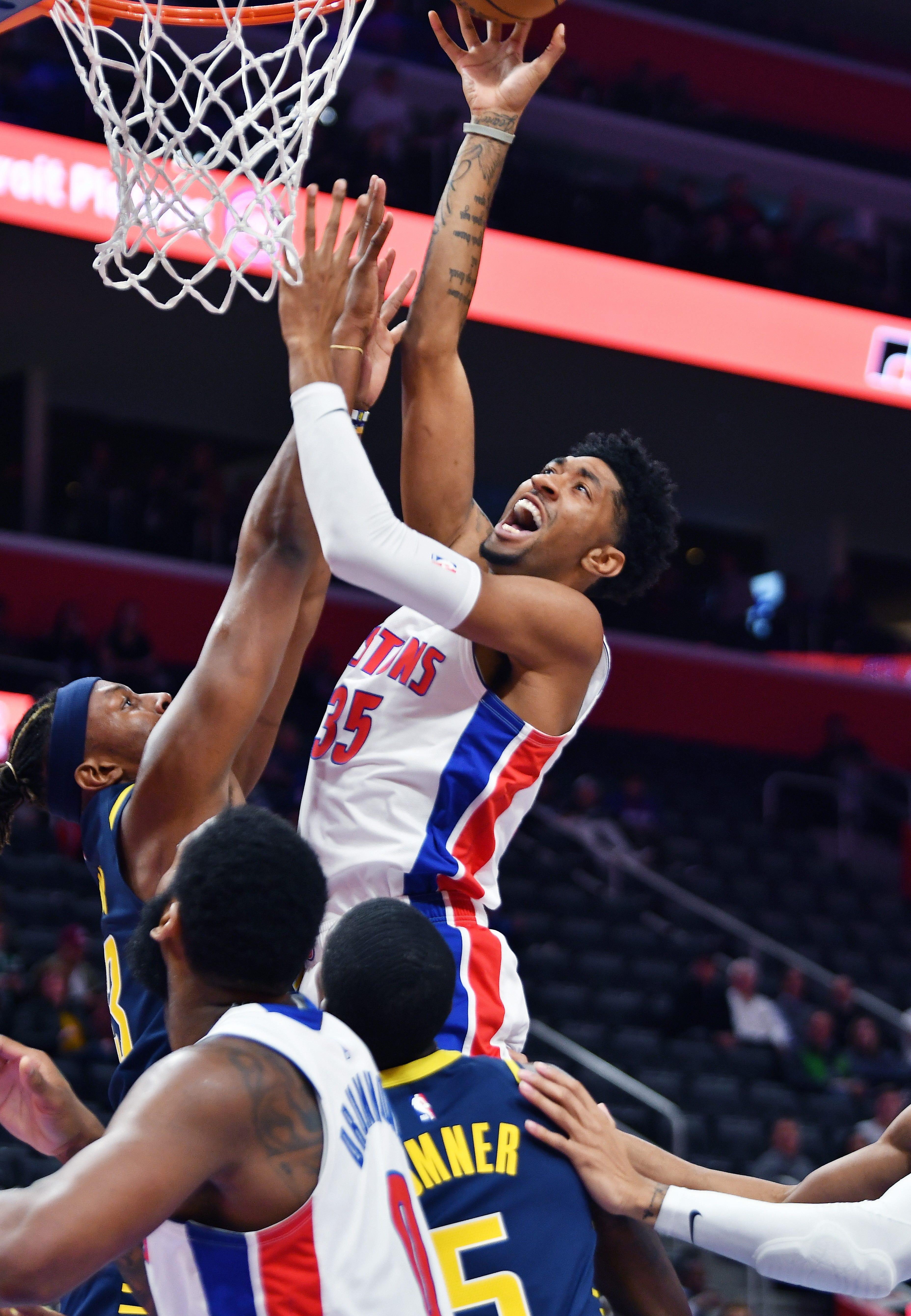 Pistons' Christian Wood scores over Pacers' Myles Turner in the first quarter.
